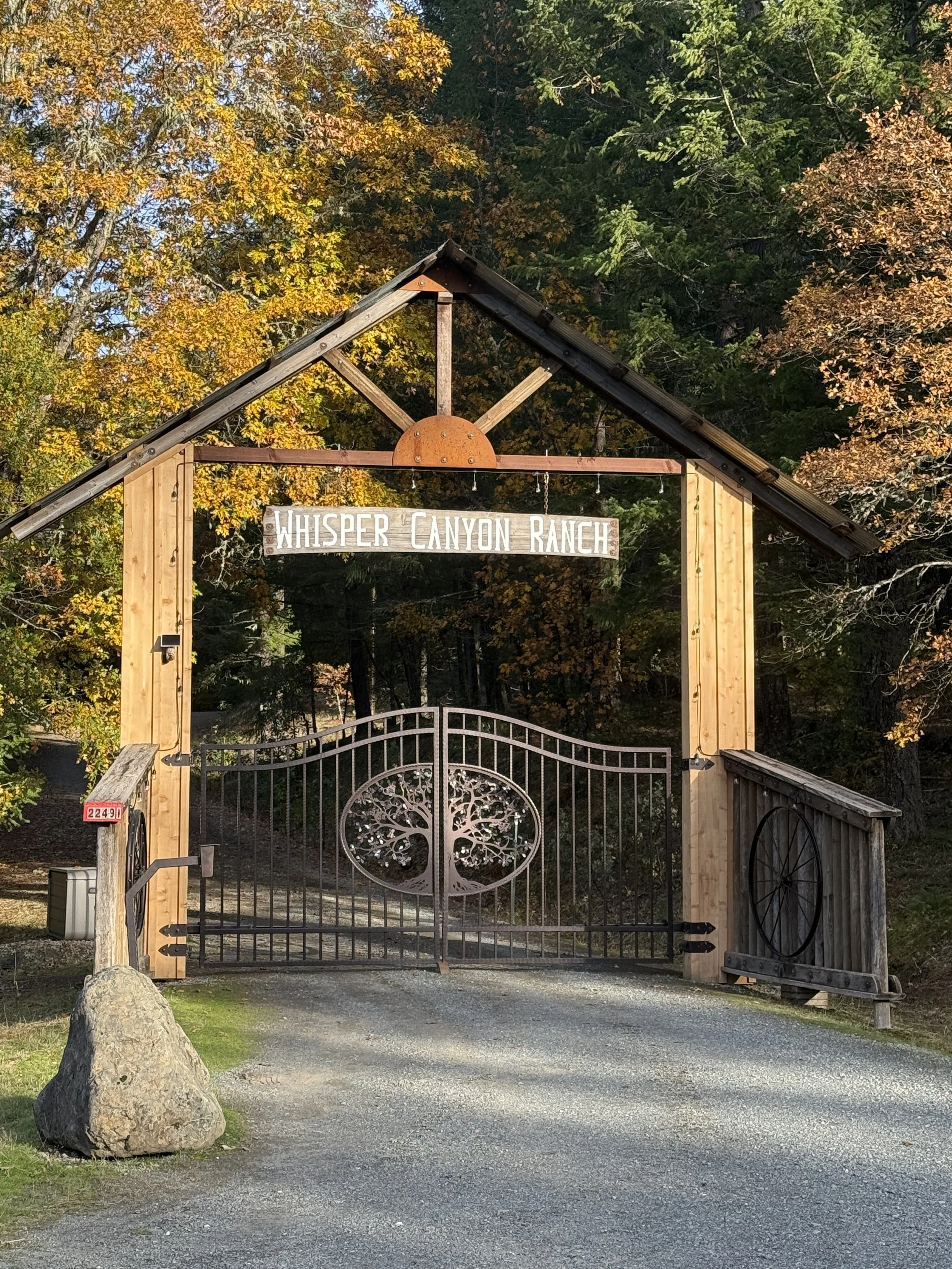 Rustic Whisper Canyon Ranch gated entrance with timber archway.