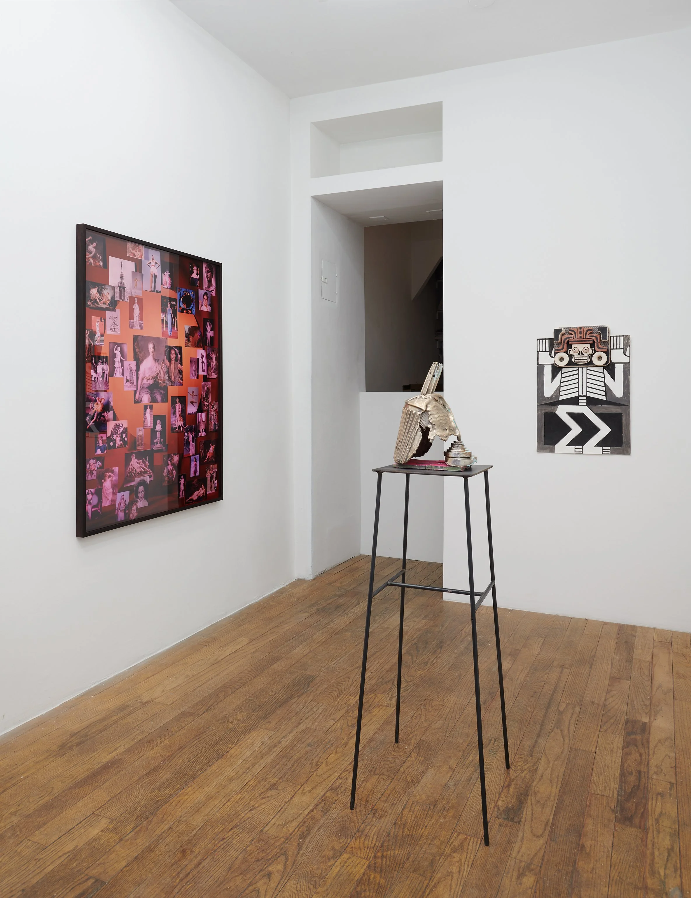  Installation view of an art gallery featuring a large framed photograph by Kim Hoeckele, a unique bronze cast helmet-like sculpture by Jennifer Macdonald, and a vertical ceramic artwork by Steve Keister mounted on a white gallery wall. 