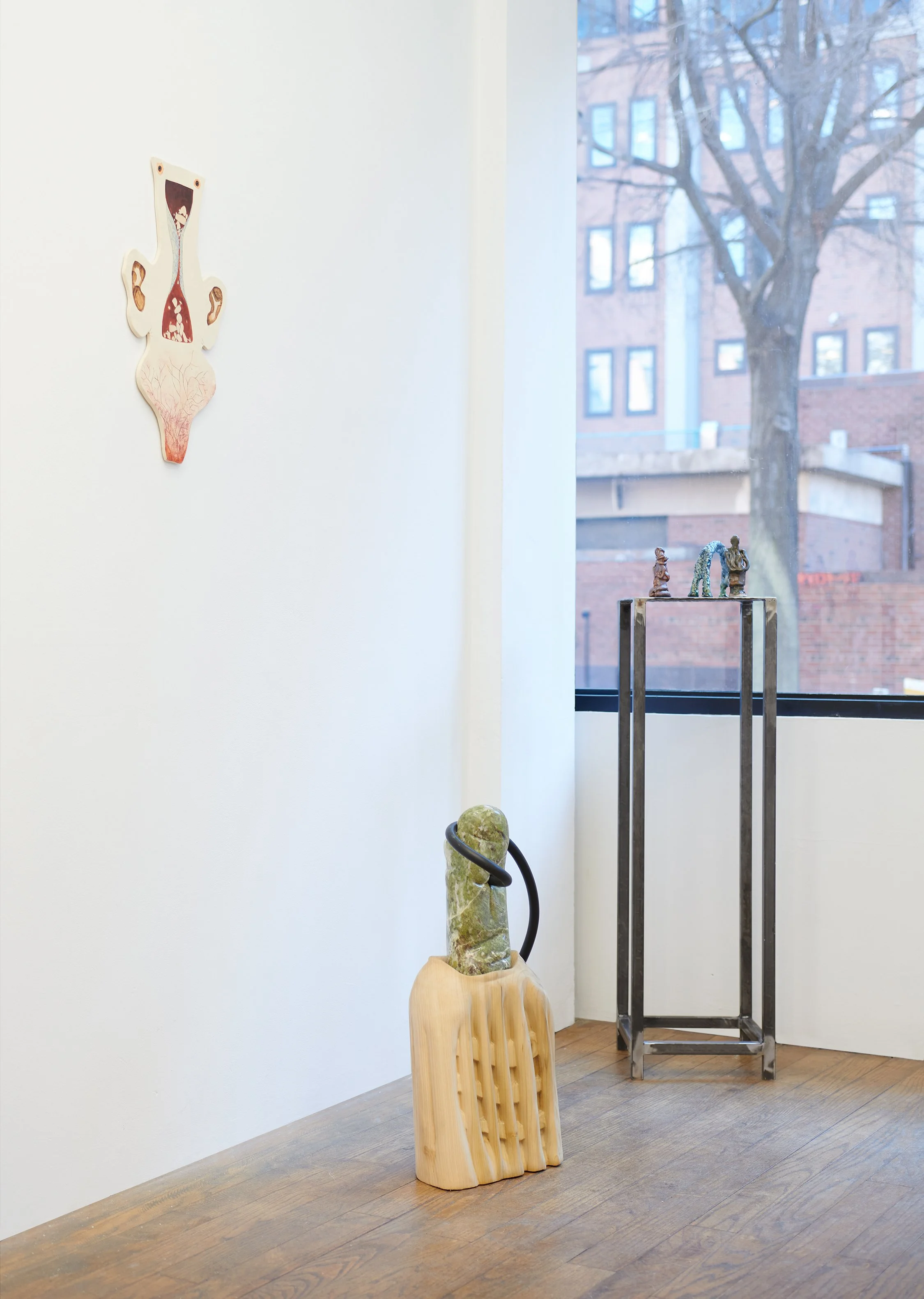  An installation view of a 20 by 12 inch contemporary porcelain sculpture by Gabriela Vainsencher titled  Bodytime , featuring mixed textures created with underglaze and acrylic,&nbsp;A three-dimensional mixed-media sculpture by Angela Conant titled 