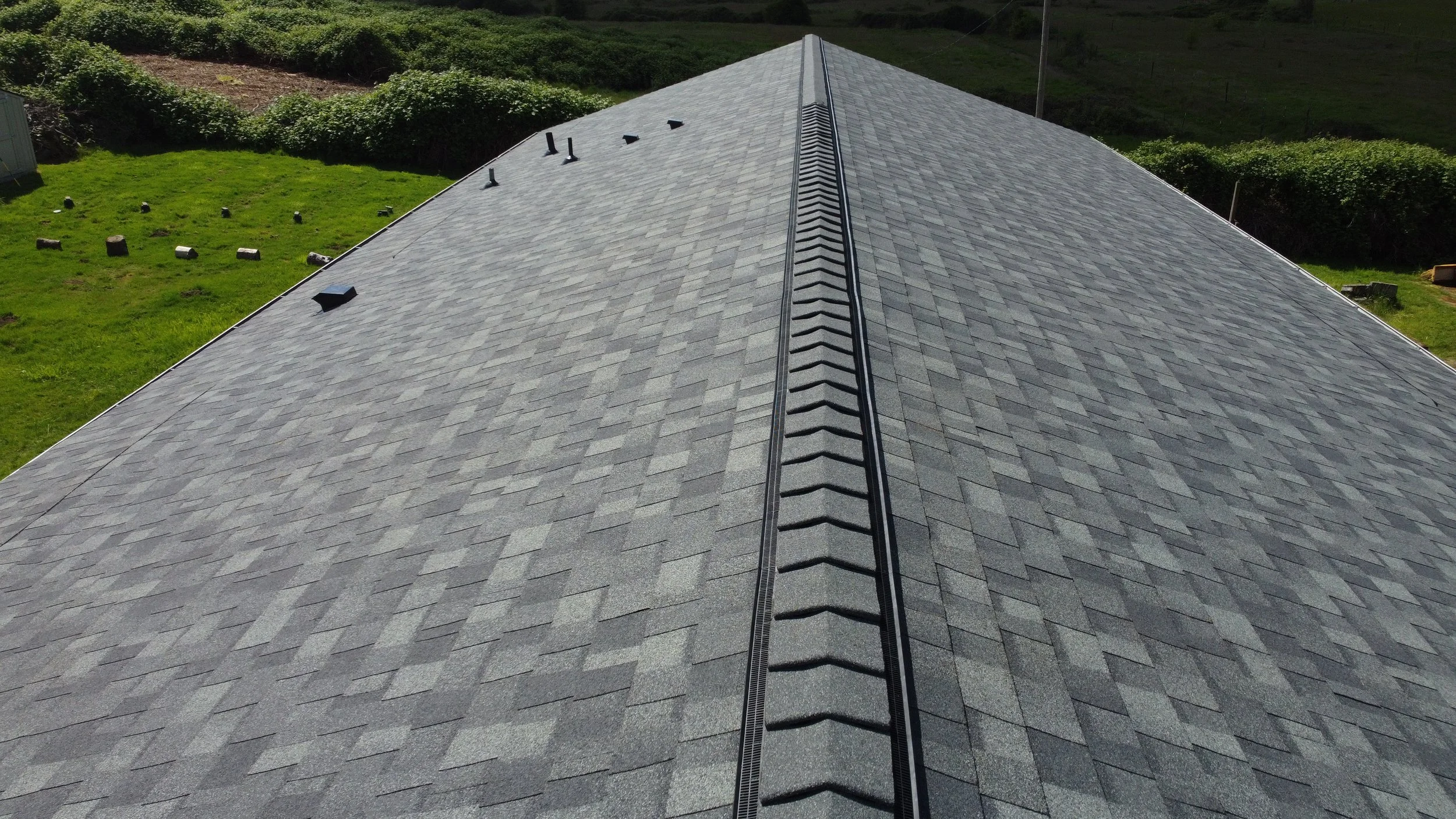 Aerial view of a house AE&I Roofing and Construction roof installation.