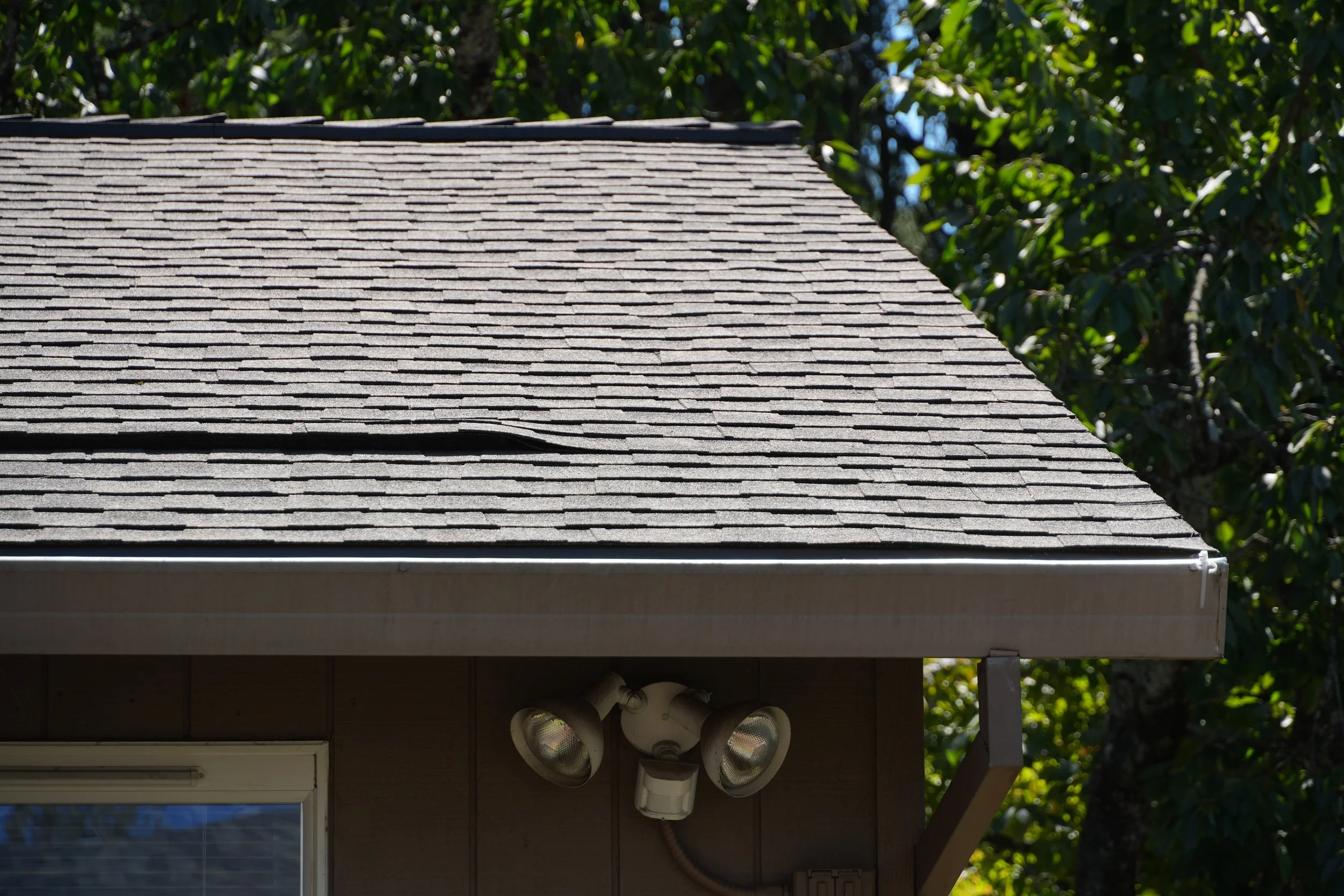Close-up of a roof and gutter installation by AE&I Roofing and Construction