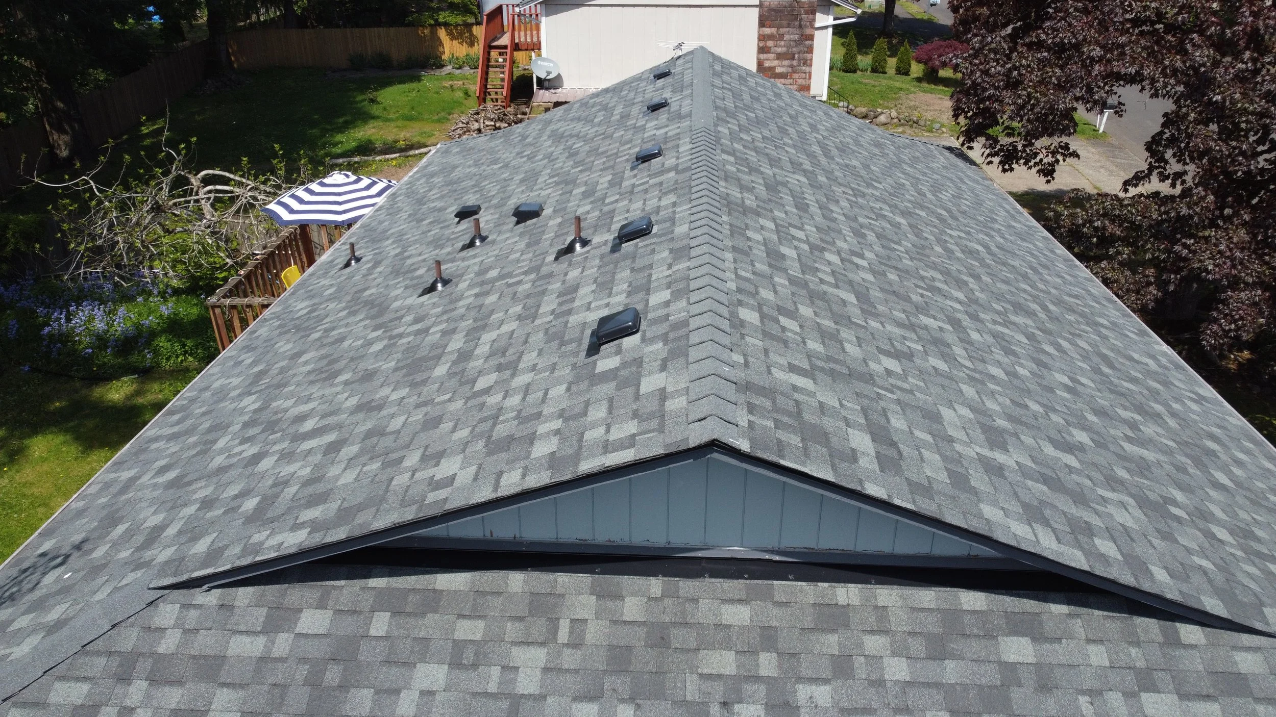 A roof install with gray asphalt shingles installed by AE&I Roofing and Construction