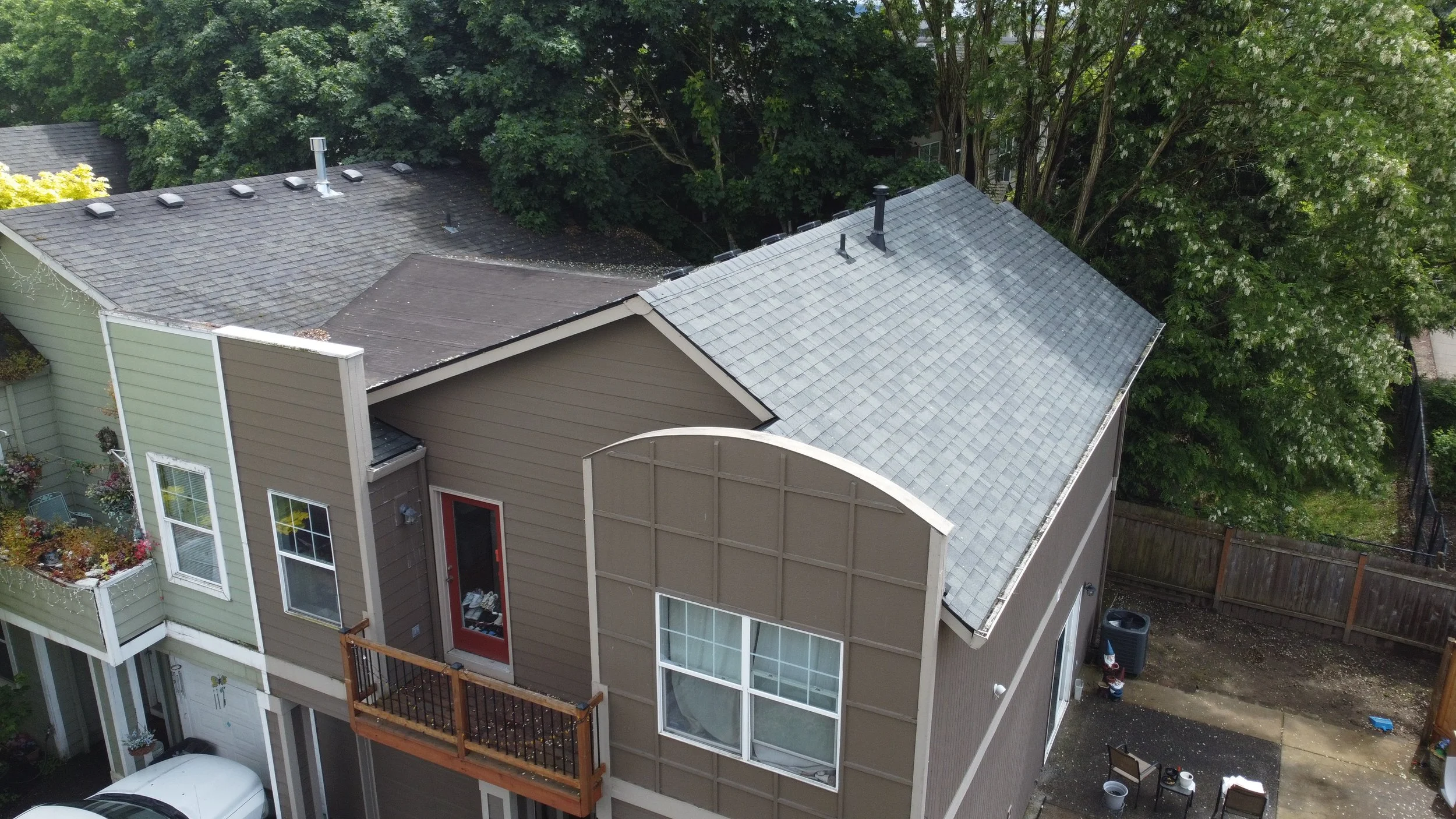 Aerial view of connected residential house roof installation by AE&I Roofing and Construction