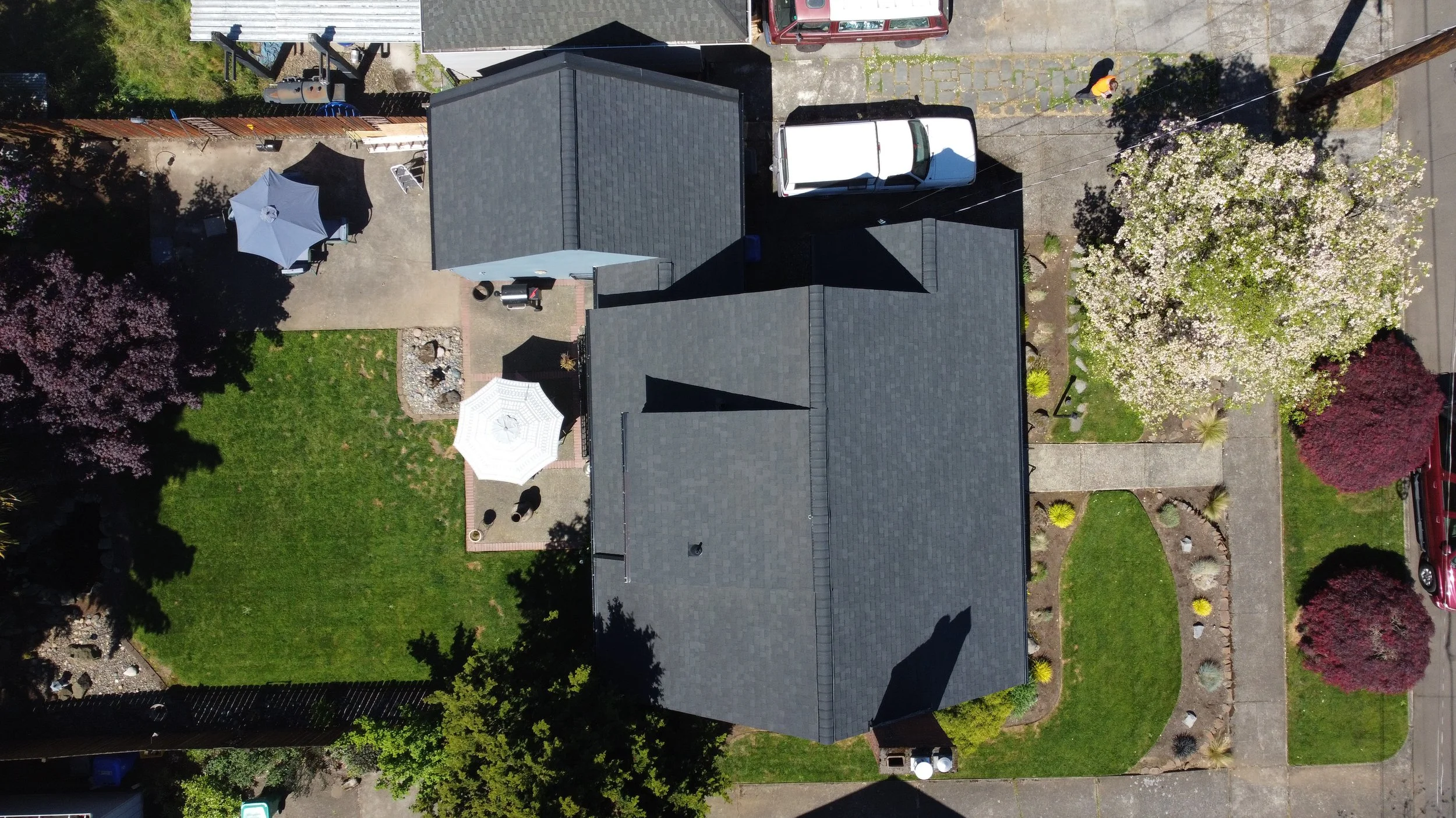 Aerial view of a house with a gray GAF roof installed by AE&I Roofing and Construction