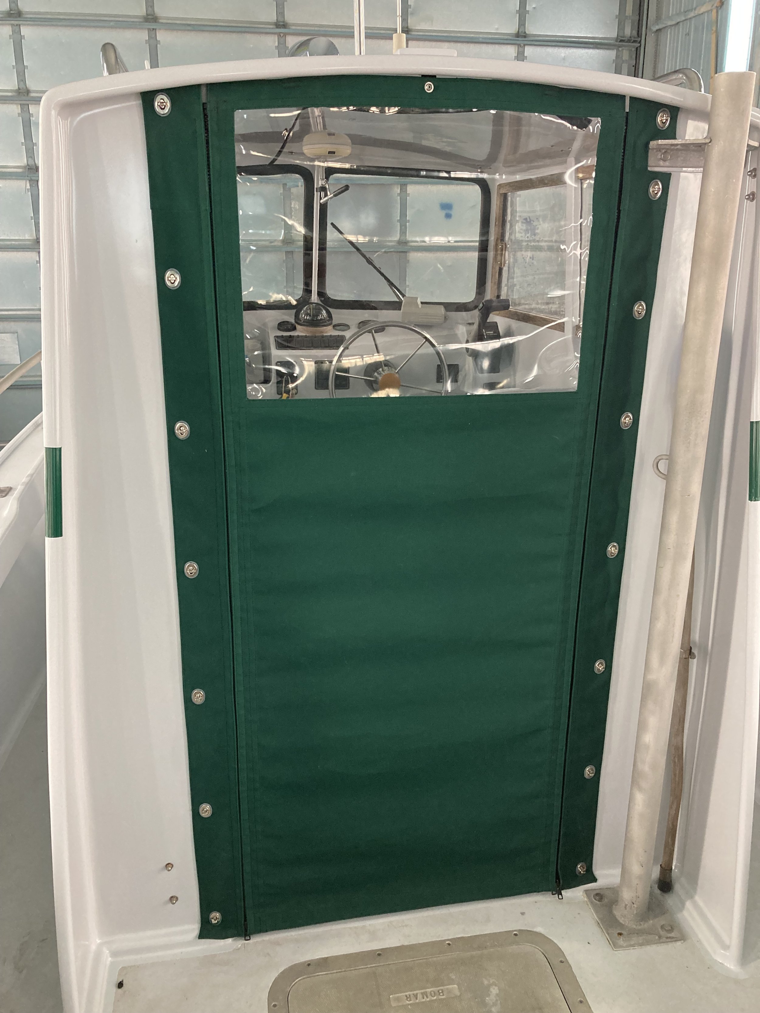 Canvas door for a small buddy cabin power boat.