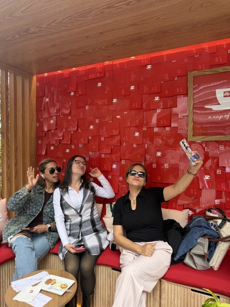 Three people taking photo together with red background