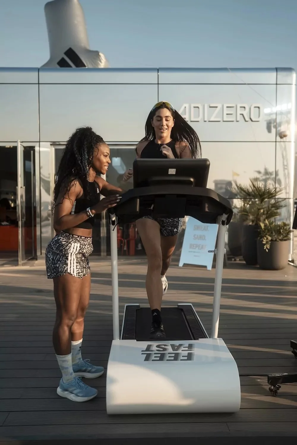 Trainer instructs athlete on treadmill at Adidas Running Hub in Dubai