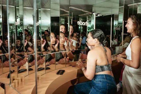 Guests experiment with Rhode beauty at a Rhode pop-up.