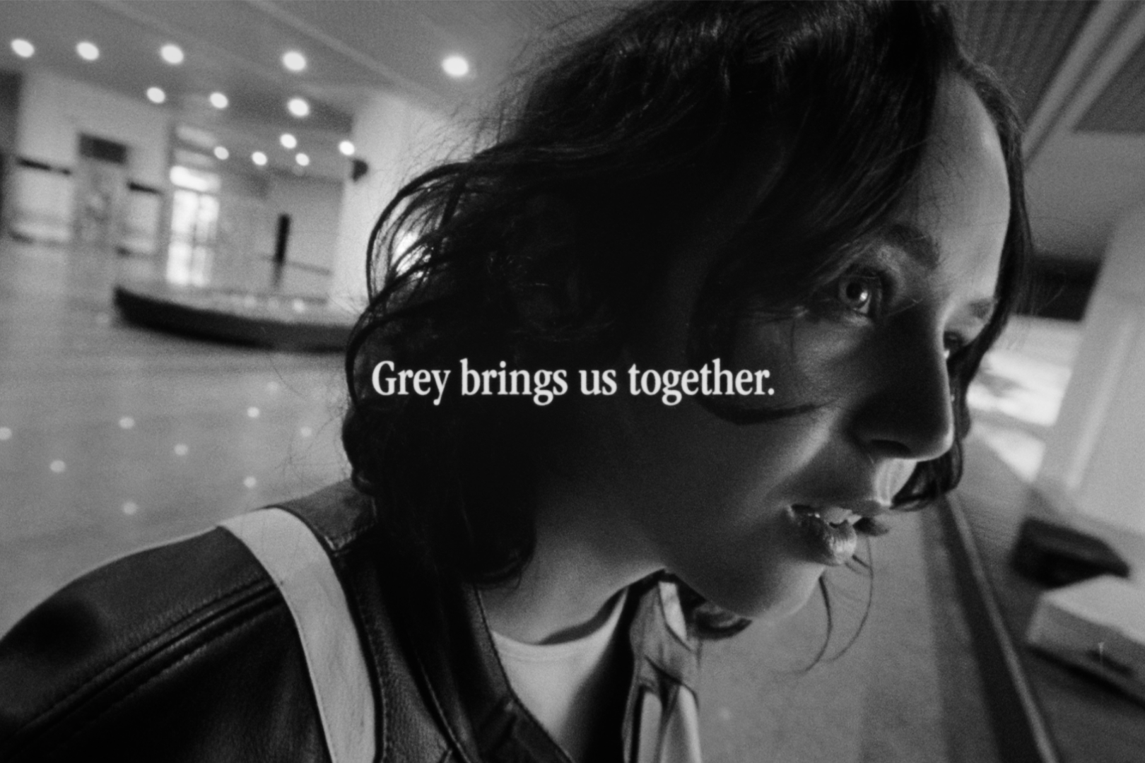 New Balance's Grey Day Campaign video snapshot of one of the characters with a text overlay, "Grey brings us together."