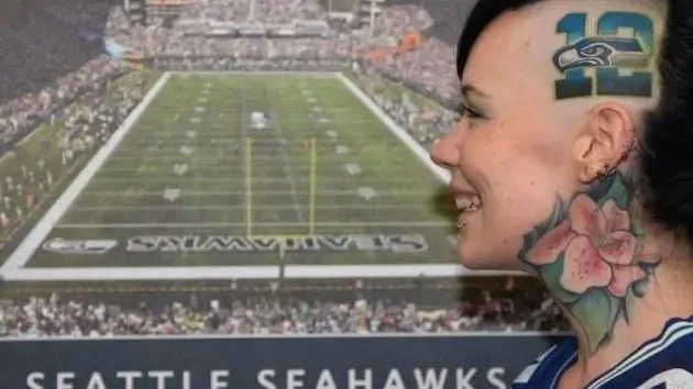 Seattle Seahawk's fan gets a tattoo on her head of the team's mascot.