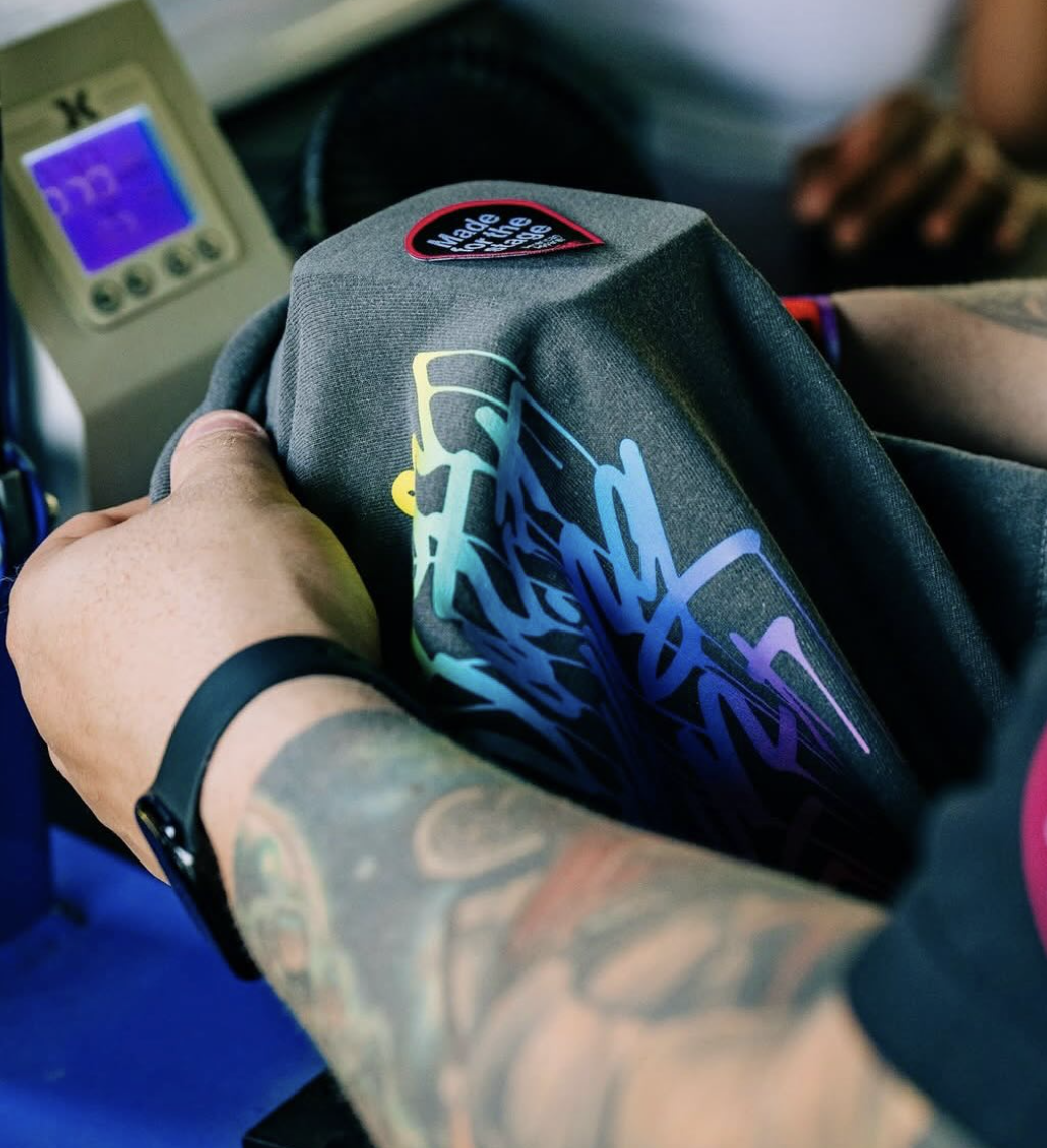 Adding a patch to a shirt at American Apparel's Tee Lab 2025