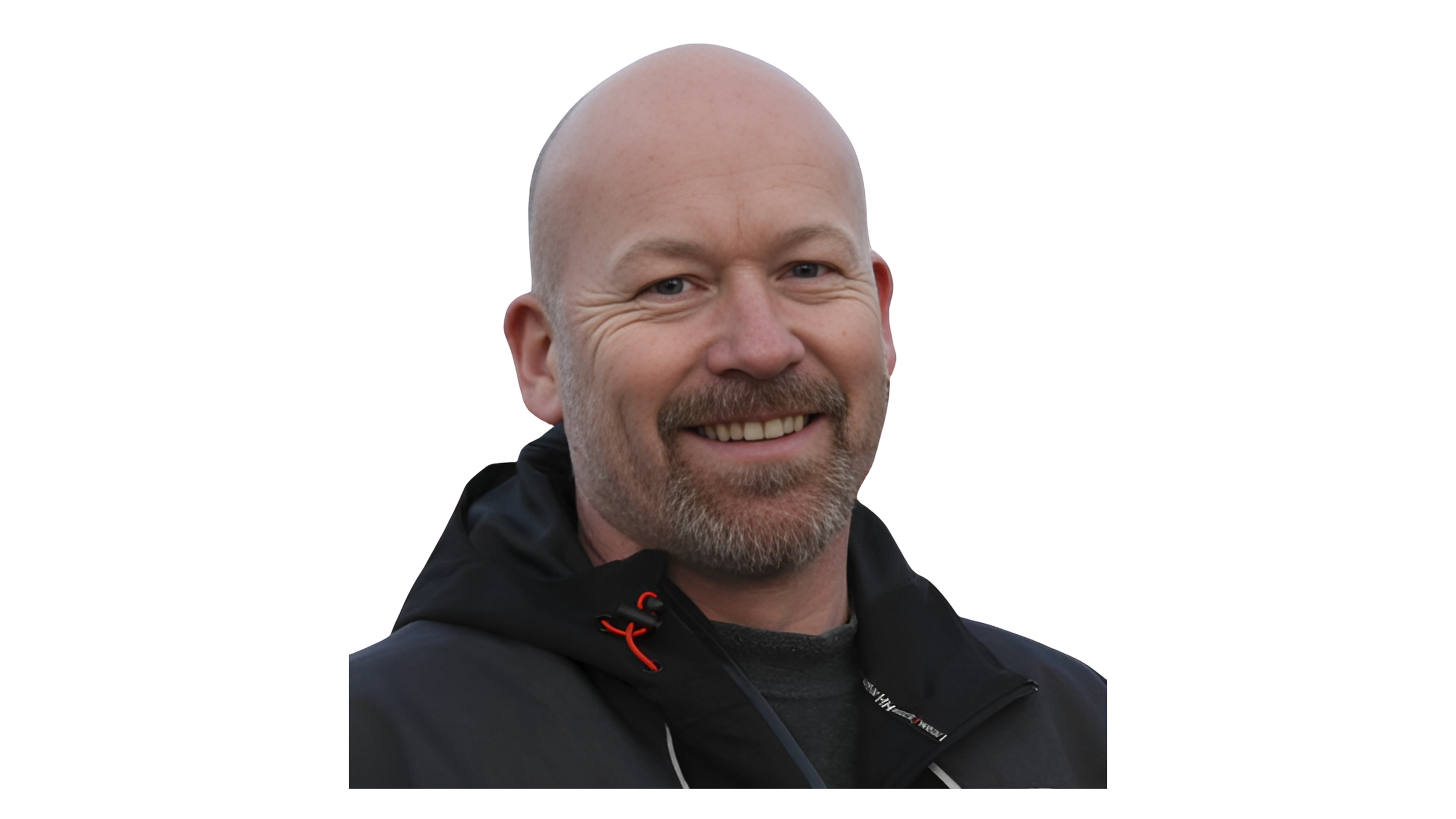 A smiling man with a bald head, beard, and mustache wearing a black jacket.