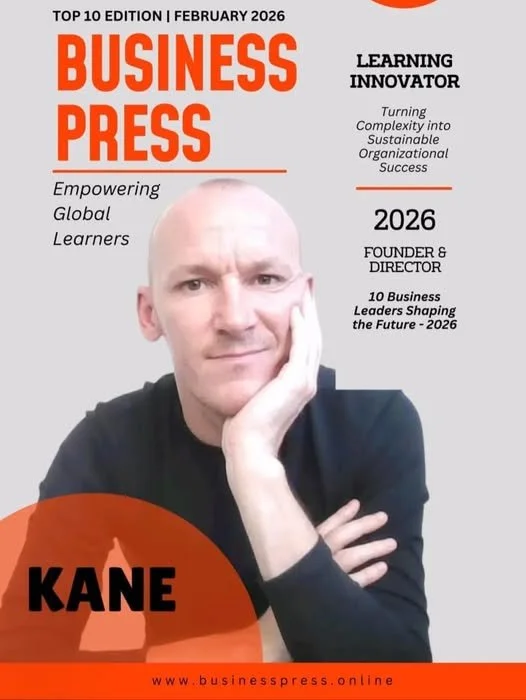 Cover of Business Press magazine, February 2026 edition, featuring a man with a bald head and black shirt resting his chin on his hand. The magazine highlights themes of empowering global learners, learning innovation, and future business leadership, with text mentioning Kane as a person of interest.