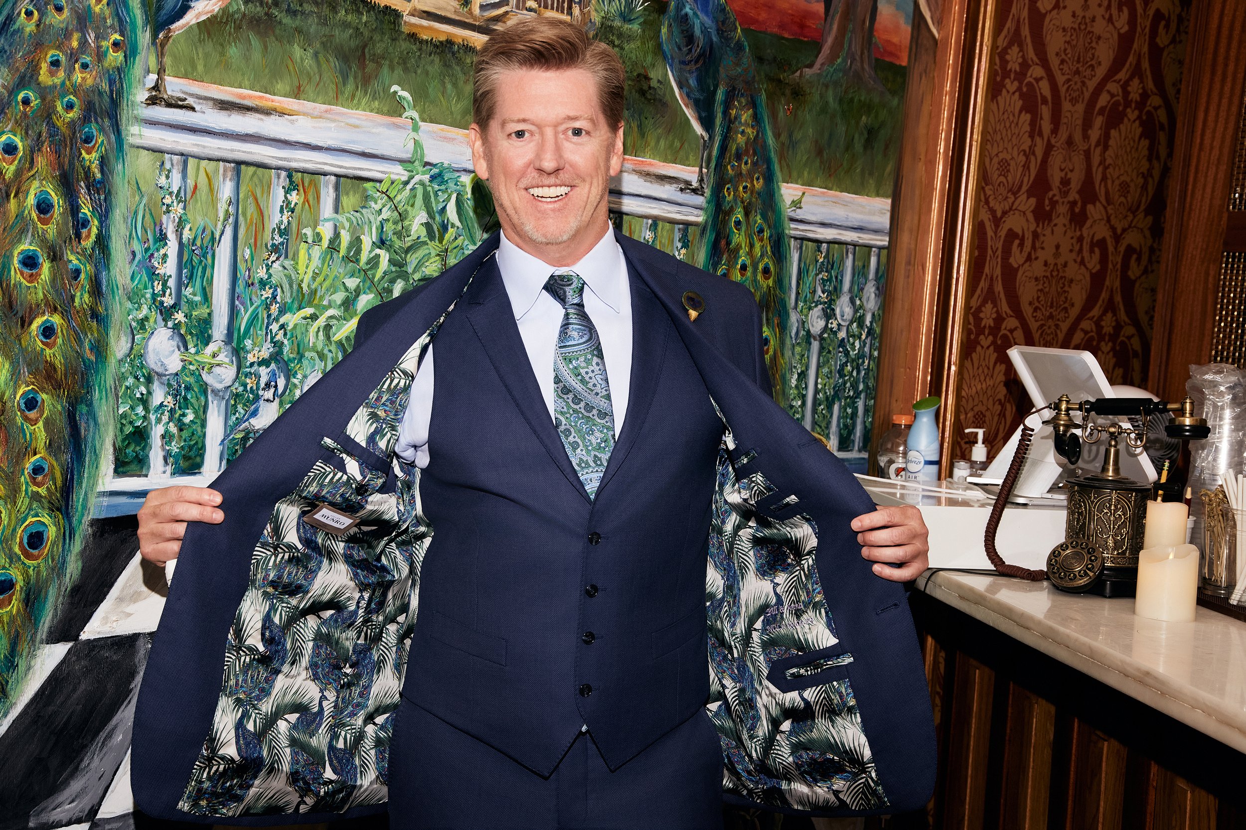 groom showing off his blazer interior details