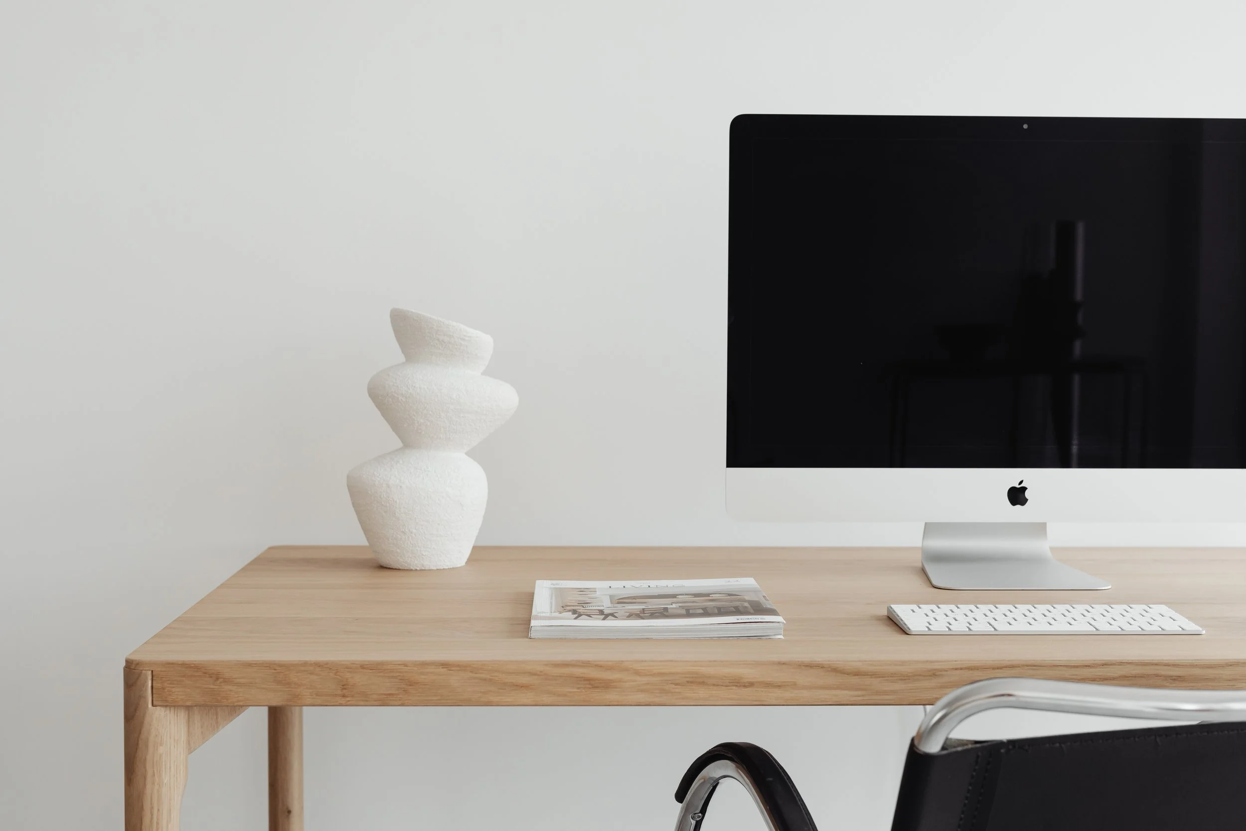 Clean workspace with desktop computer representing a streamlined AI business system built around a primary workflow and organized digital tools.