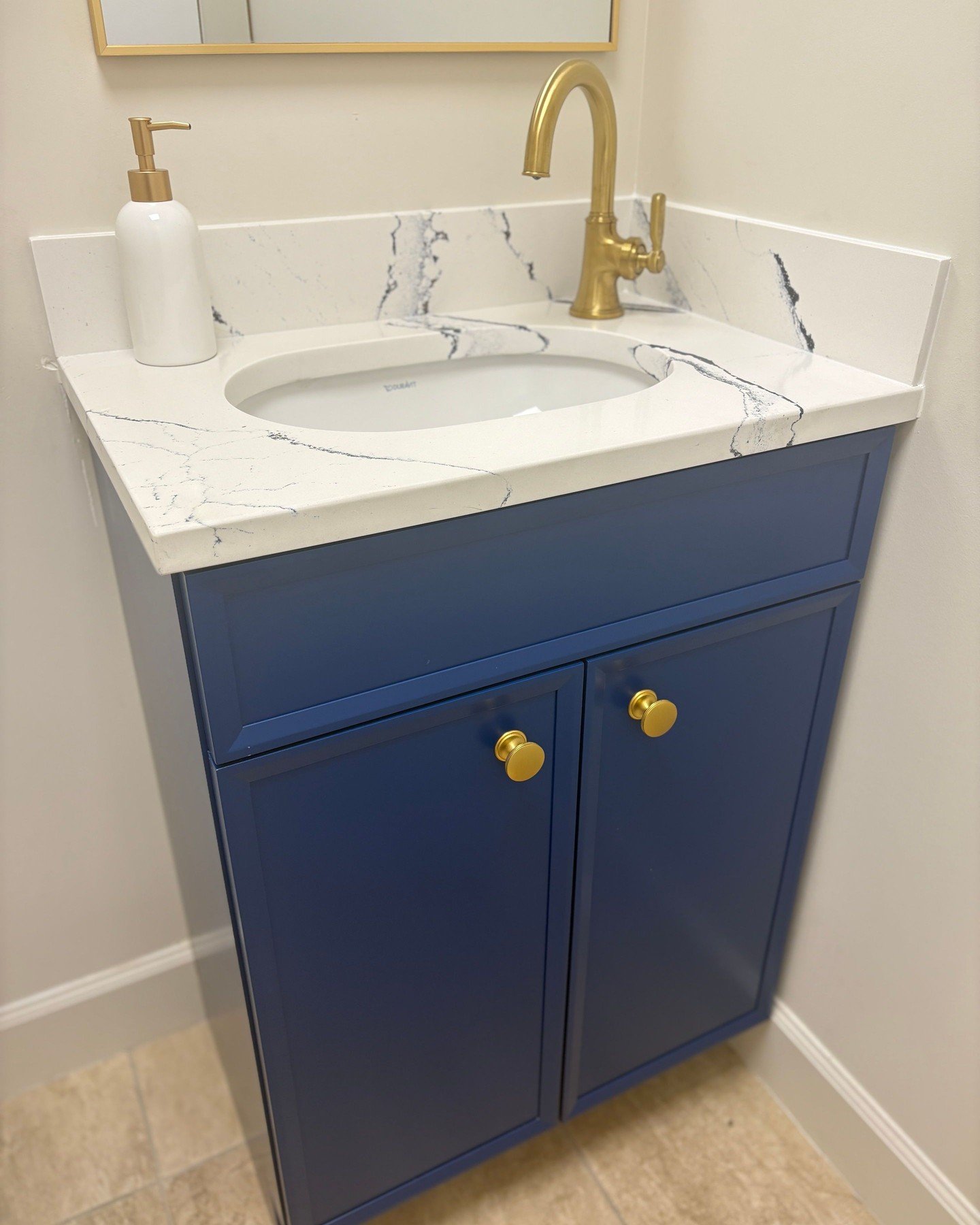 Bold. Elegant. Custom.
This deep-blue vanity paired with a veined quartz top and brushed gold hardware creates a perfect balance of sophistication and warmth while adding a touch of fun to your home.

Every detail is crafted with intention&mdash;beca