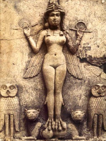 Ancient stone carving of a female figure with wings, surrounded by four animal-like figures.