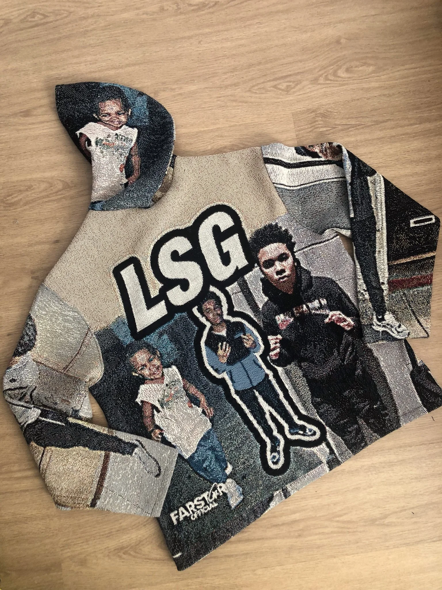 Close-up of a fabric with a printed design featuring several people, one of whom is a woman with short hair and glasses, and a large logo that reads 'LOSSG' and 'FORCES'.
