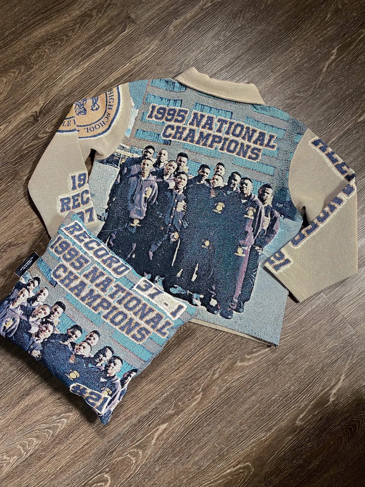 Colorful embroidered sweater featuring a group photo of soccer players and text celebrating the 1995 national champions.