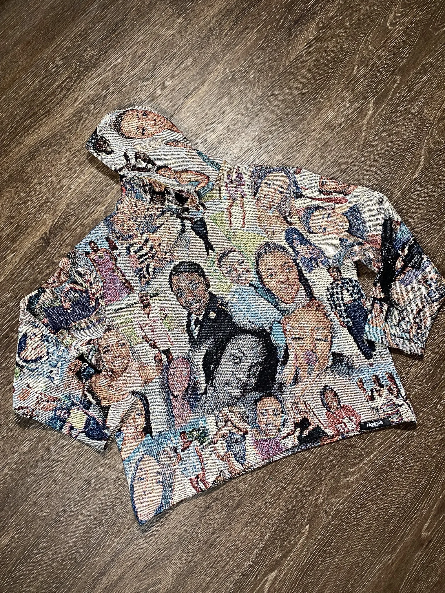 A newspaper-style cloth with portraits of various women, laid on a wooden surface.