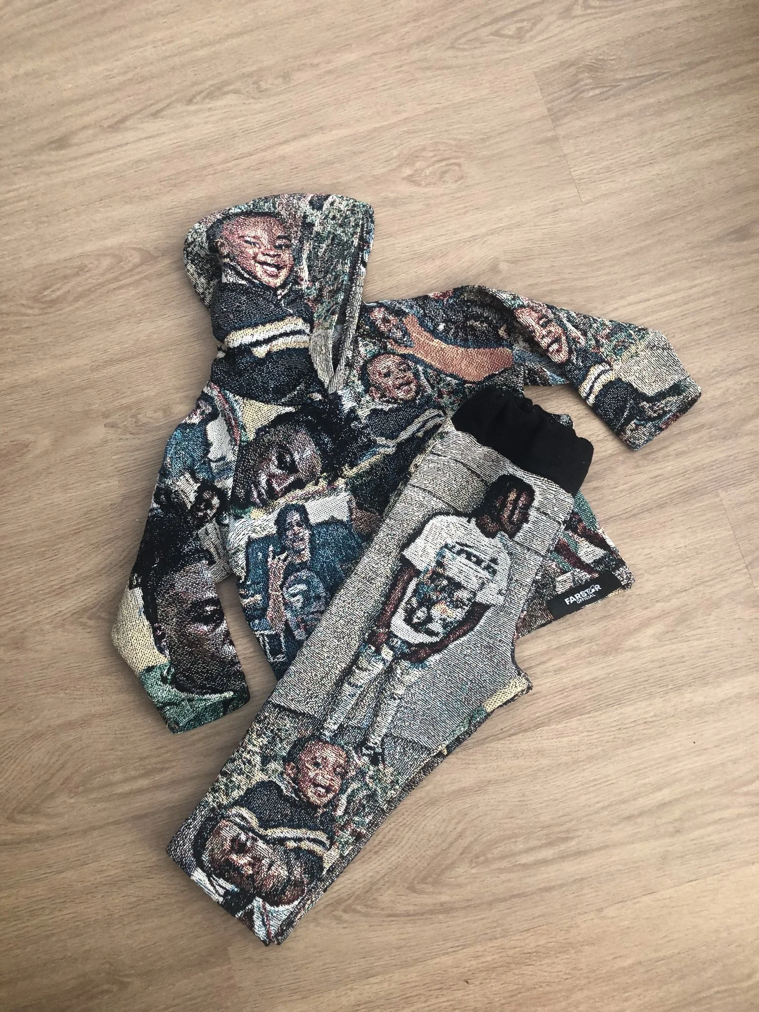 A pair of socks featuring a detailed embroidery of a person's face, likely a celebrity, with various other faces and images woven into the fabric.