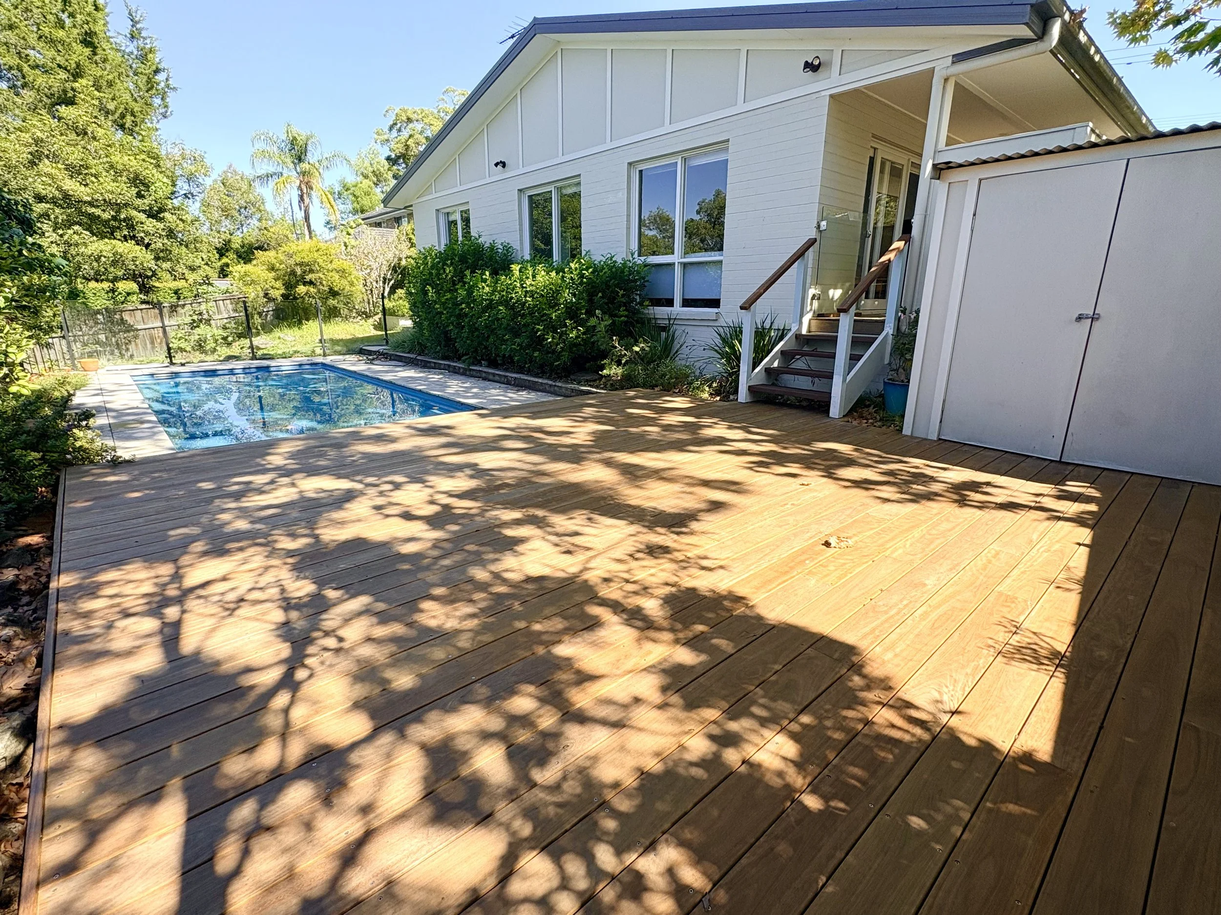 A brand-new deck with a small, beautiful set of stairs.