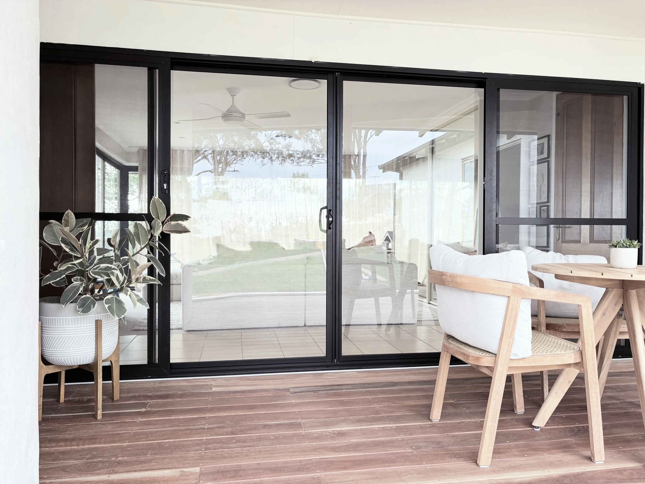 New black aluminium sliding door window with a spotted gum deck; a warm, modern space perfectly designed for relaxation and every day living.