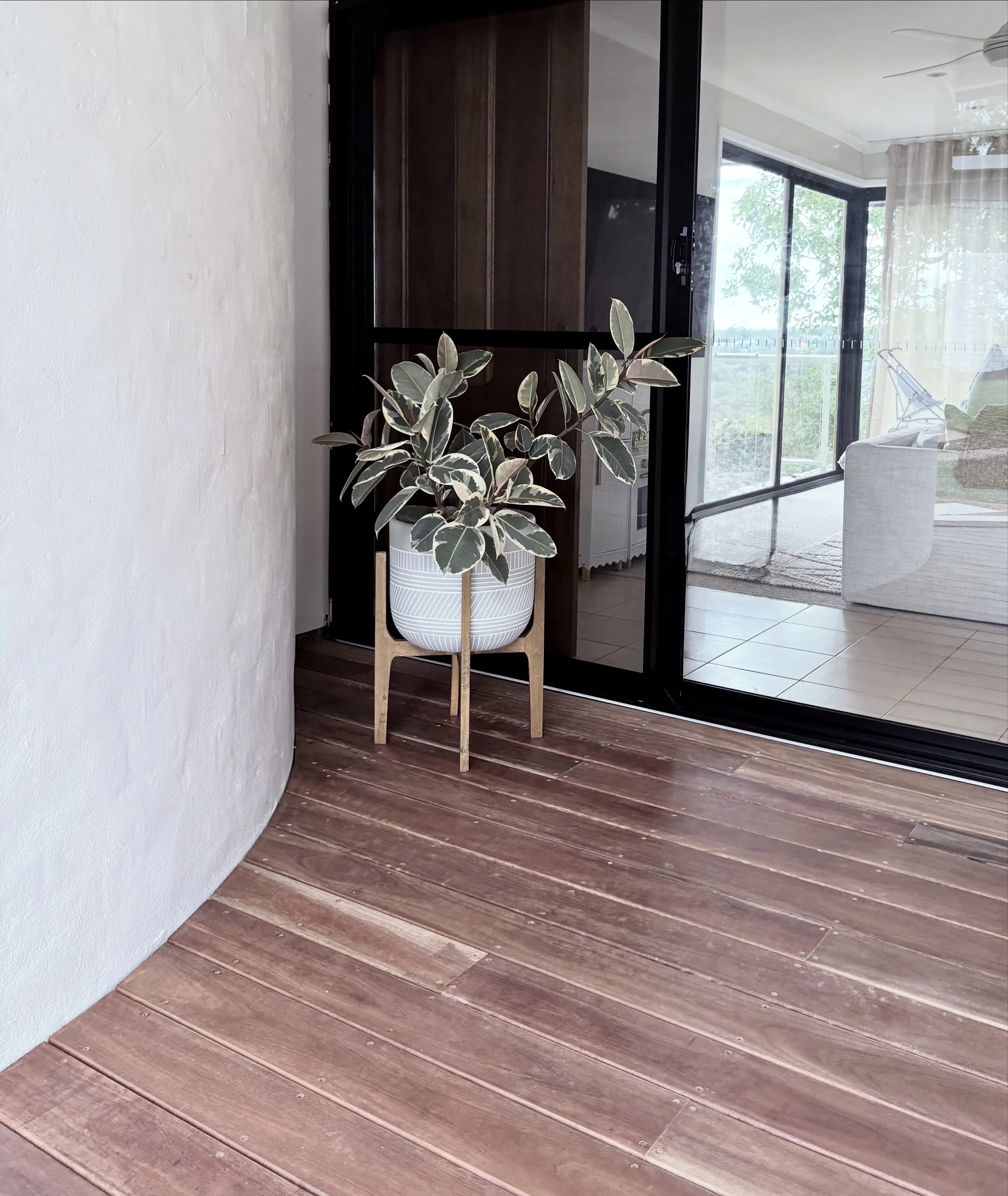 New black aluminium sliding door window with a spotted gum deck; a warm, modern space perfectly designed for relaxation and every day living.