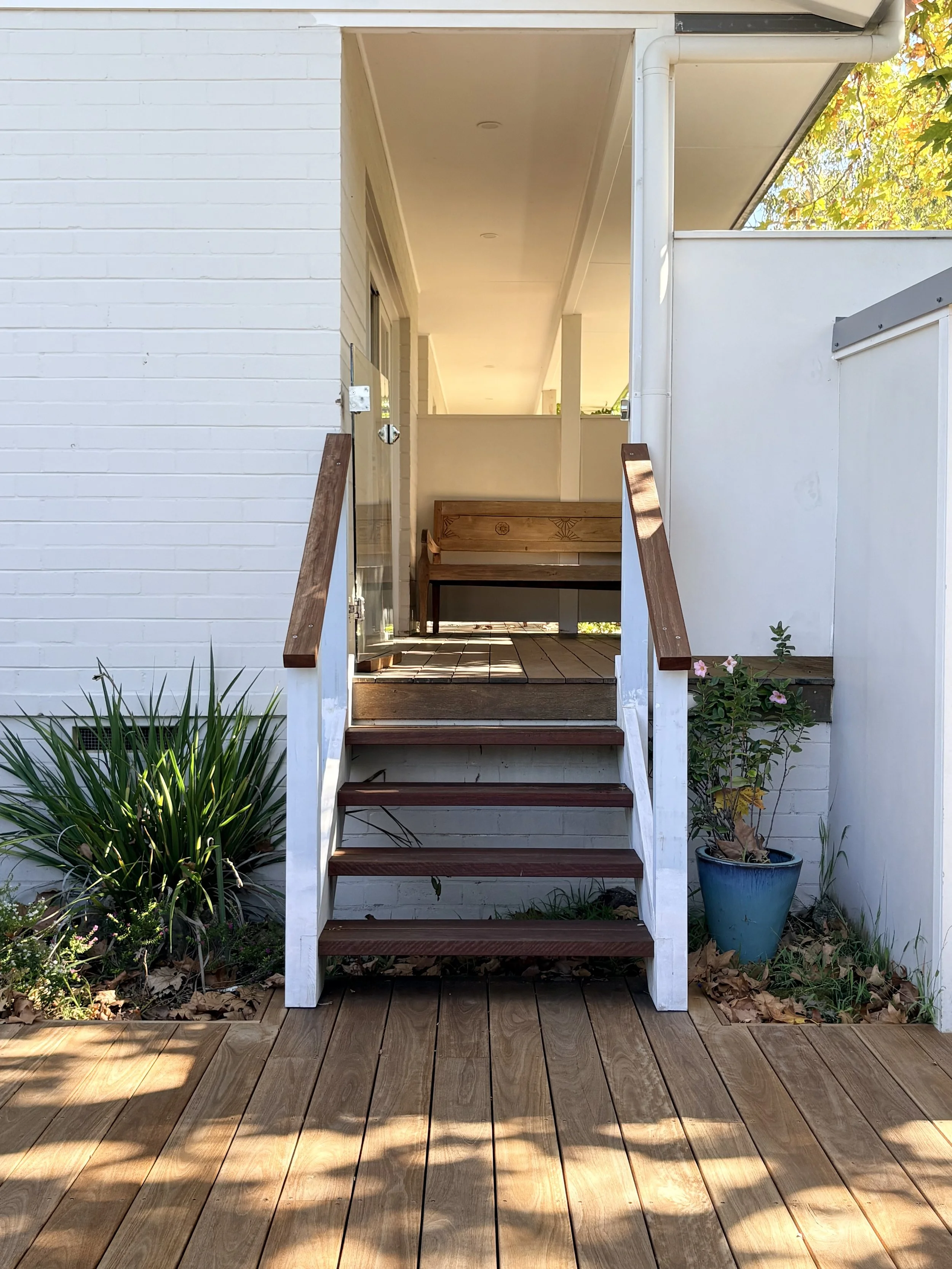 A small set of stairs landing onto a brand-new deck, built to last.