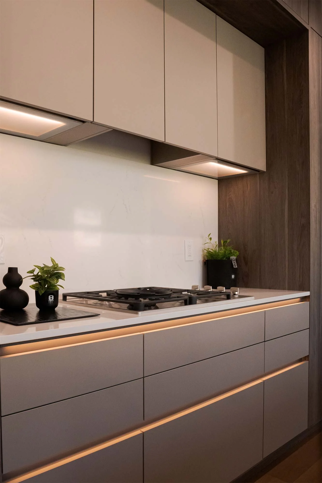 Modern design made simple: handle-free compartments with lighting that defines the space.