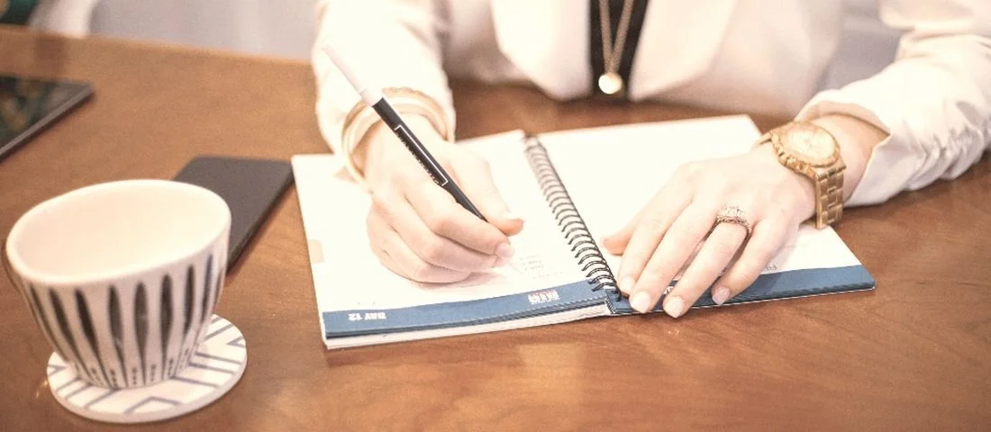 Reading your own lab results: a notebook, a pen, and a cup of coffee on a desk