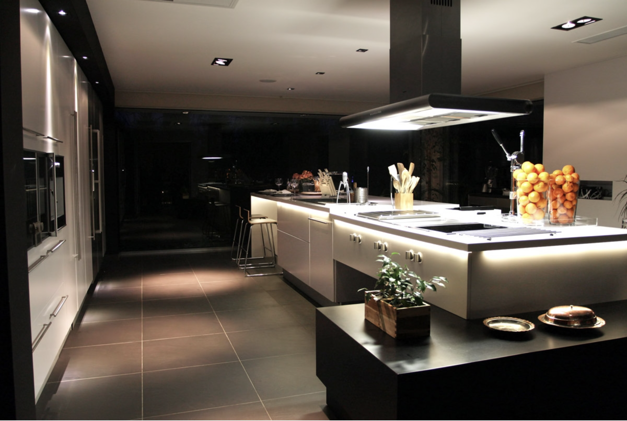 the central island of modern kitchen - white cabinets, dark walnut and black accents and stainless steel appliances.png
