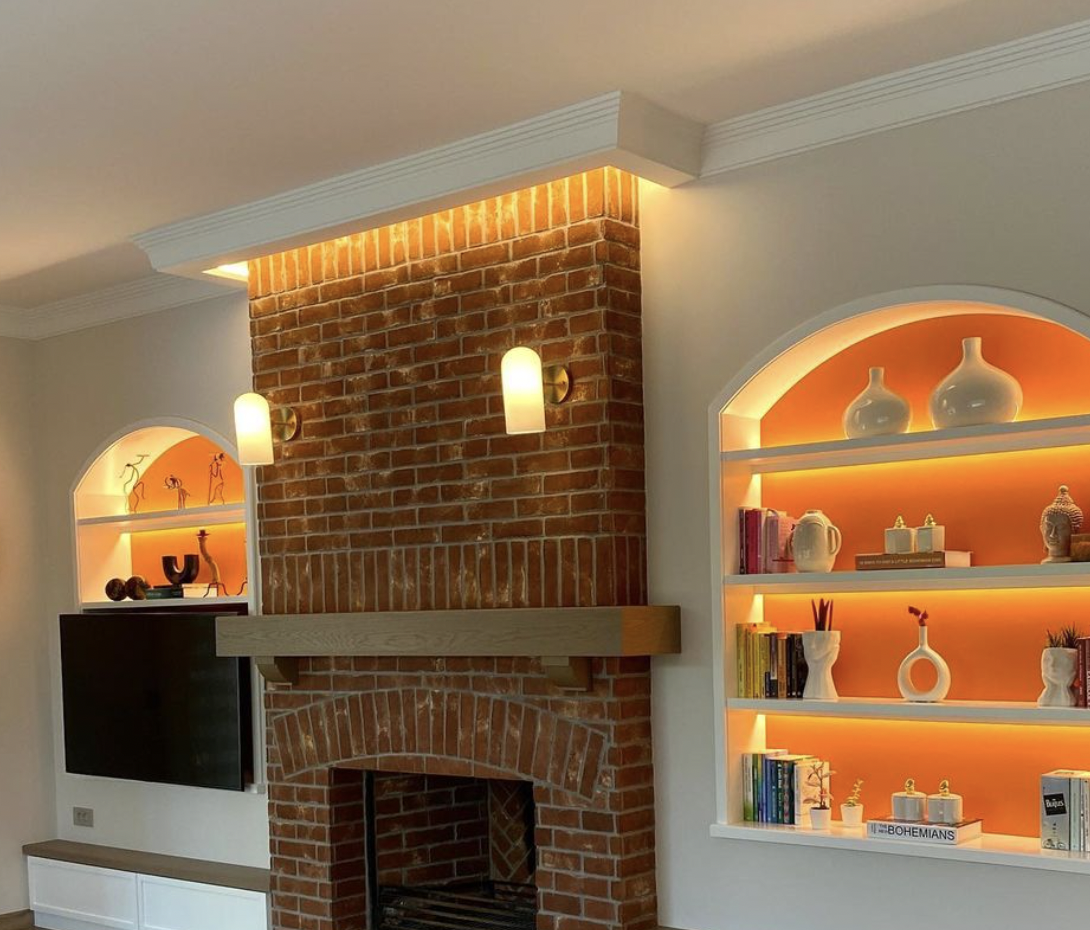 The recessed shelves with embedded back light as the fireplace wall units.