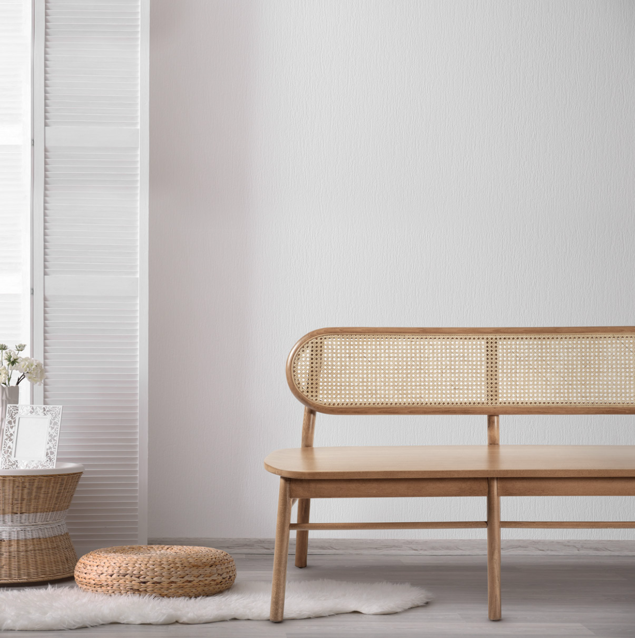 NOMO handmade wooden bench and matching chairs with woven Hazeran backrests in a sunlit modern interior, by Nuovo Vancouver.