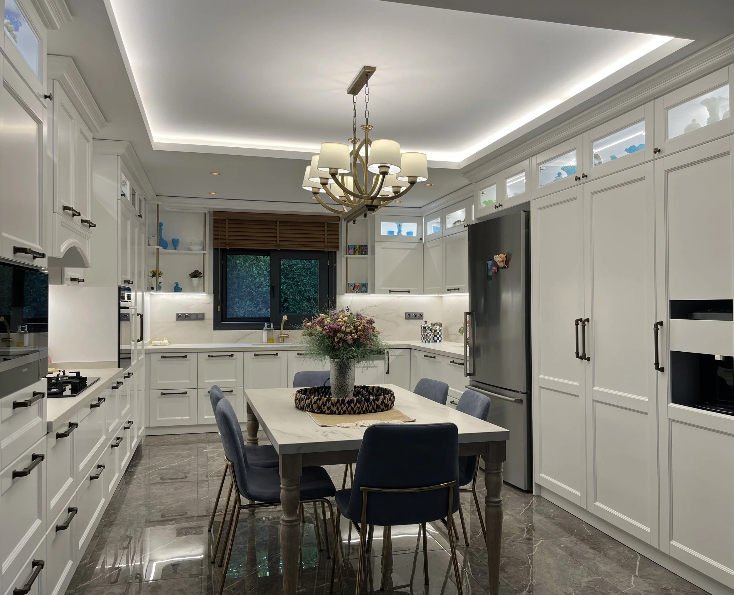 Soft off-white shaker cabinetry featuring traditional black Häfele hardware and a seamless full-height quartz backsplash.