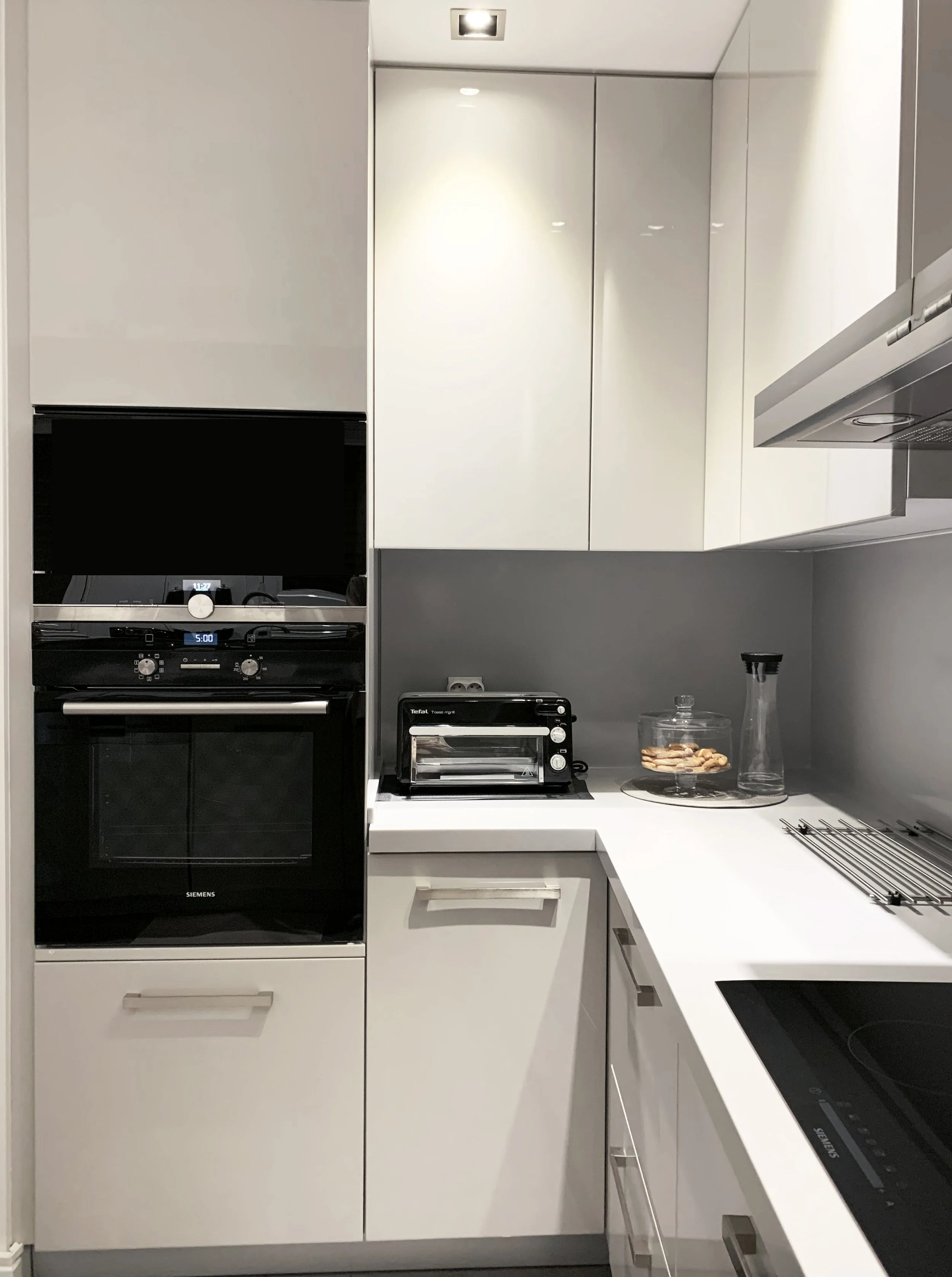 Integrated LED lighting in a white gloss European-style kitchen, perfect for modern Vancouver condo renovations.