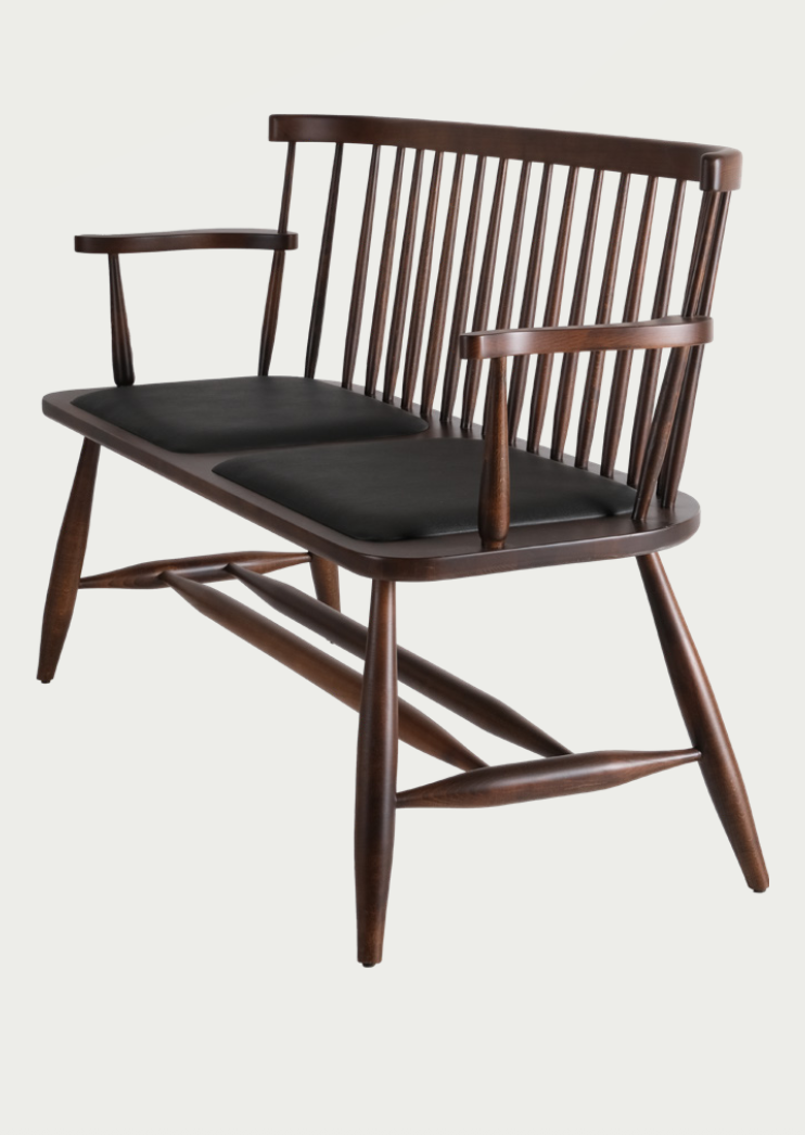 Artisan NOMO walnut bench with luxury dark green upholstery and steam-bent wood frame for high-end living spaces; by Nuovo Kitchens Vancouver.