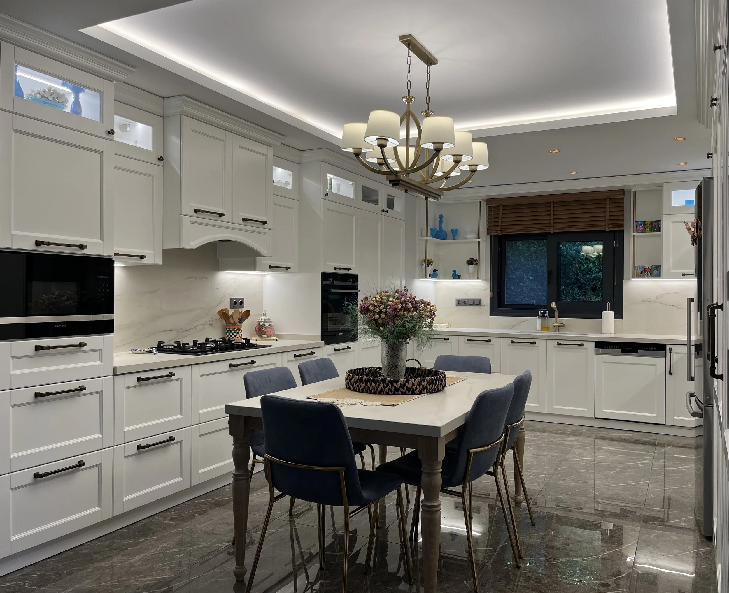 Bespoke dining table custom-made by NUOVO with a Cosentino quartz top to match the kitchen countertops and backsplash.