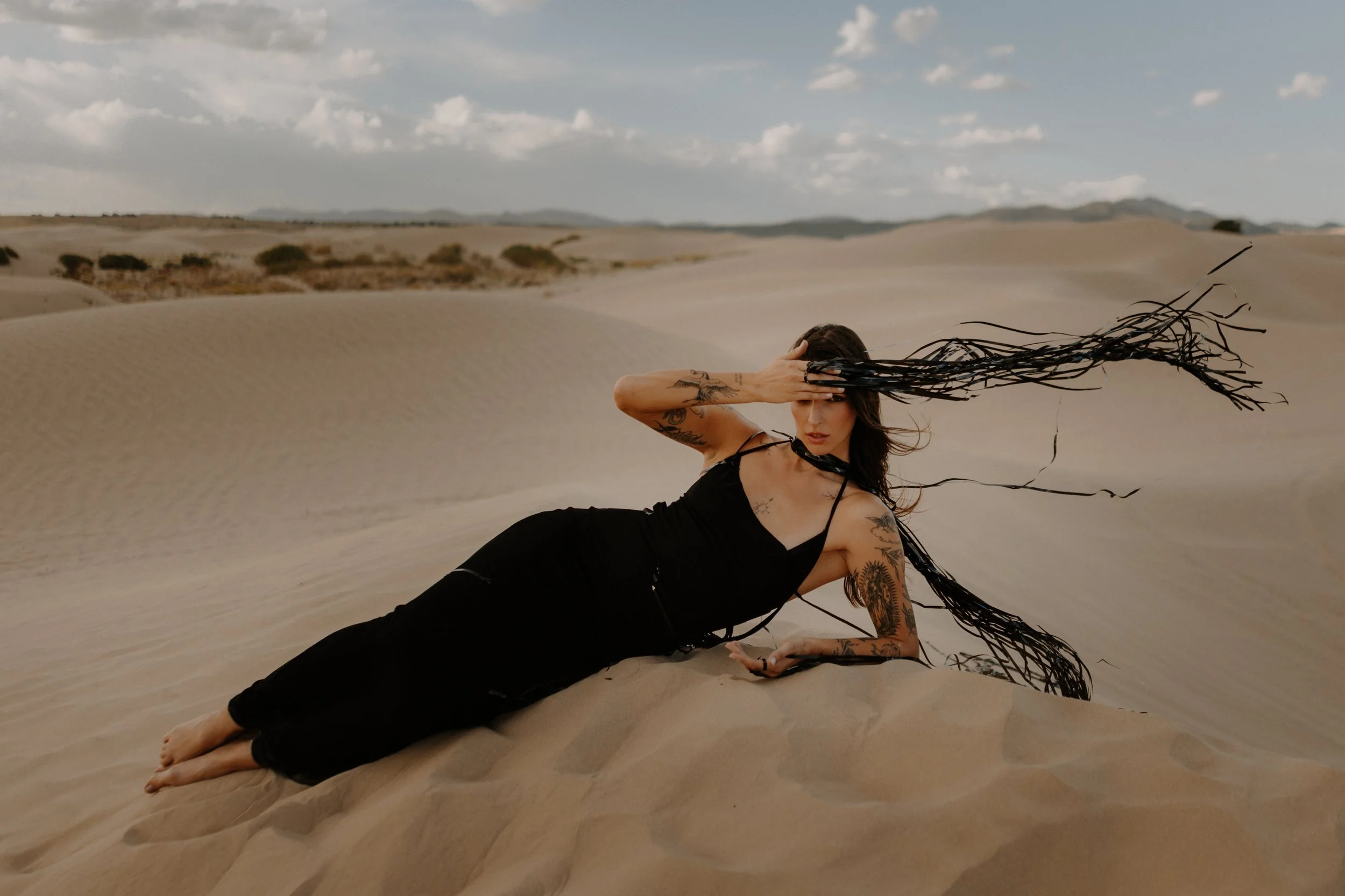 Editorial fashion shoot on Utah sand dunes, showcasing flowing fabric and golden textures at Little Sahara.