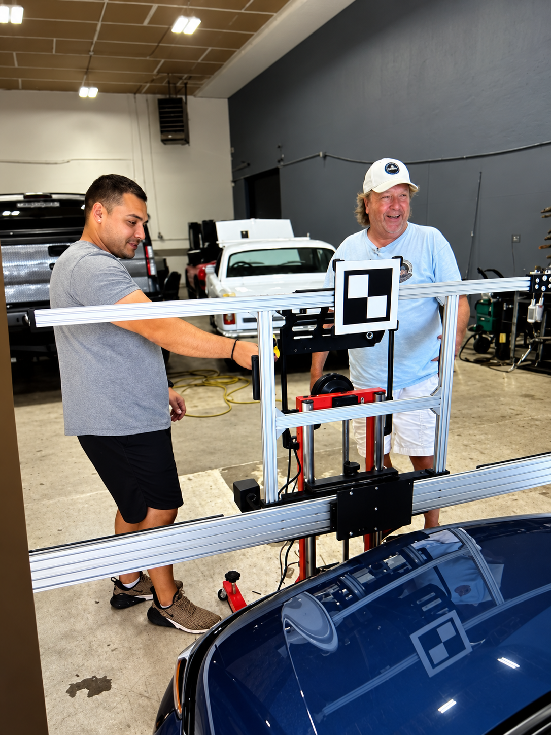 John’s Auto Glass team working with ADAS calibration equipment in the shop