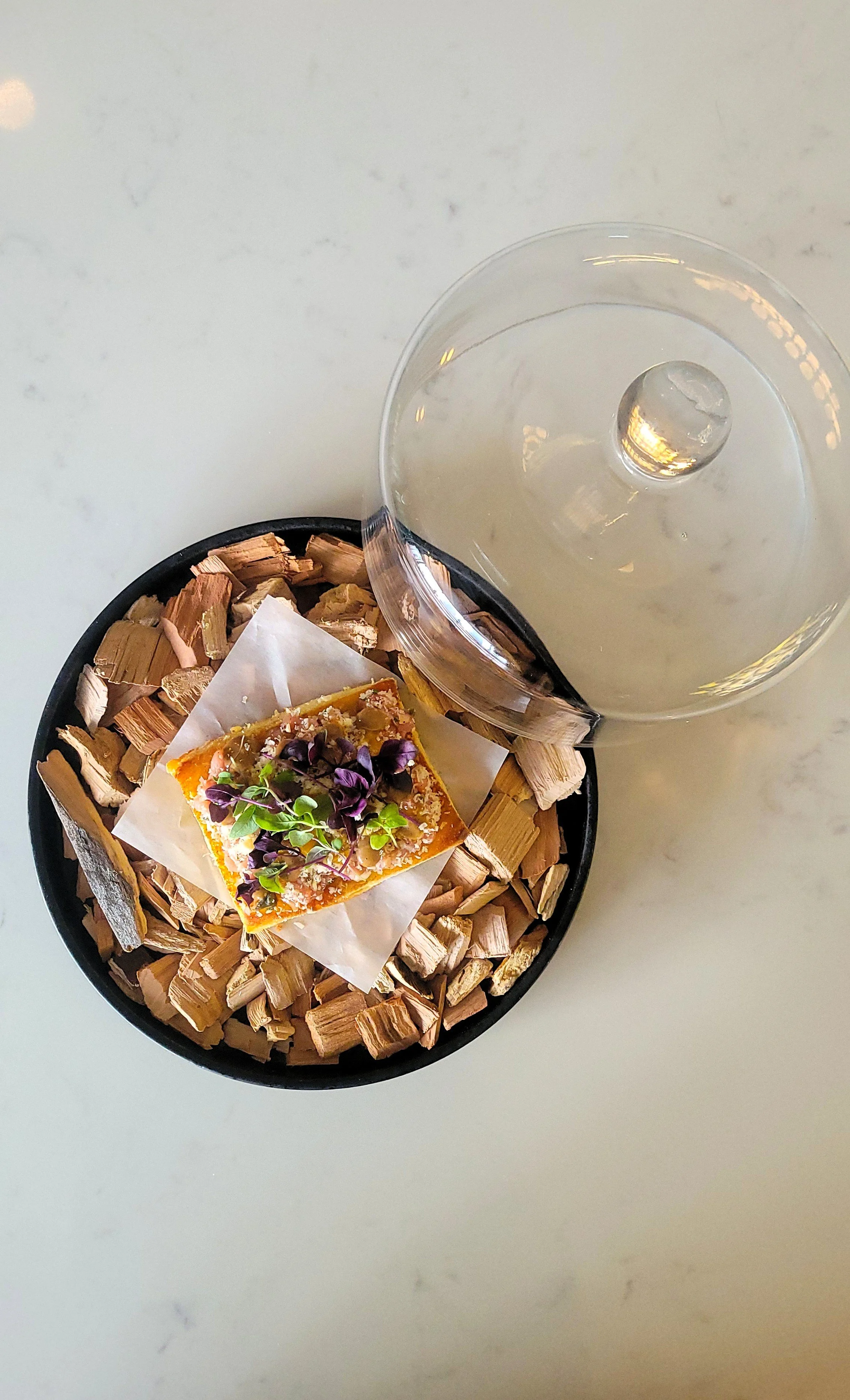 foie gras toast on plate of wood chips