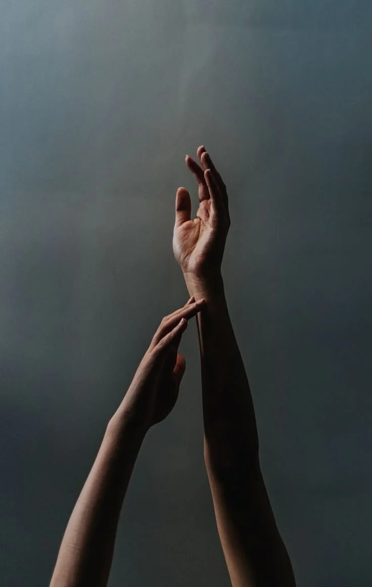 Close-up of a person's hand resting on their knee.