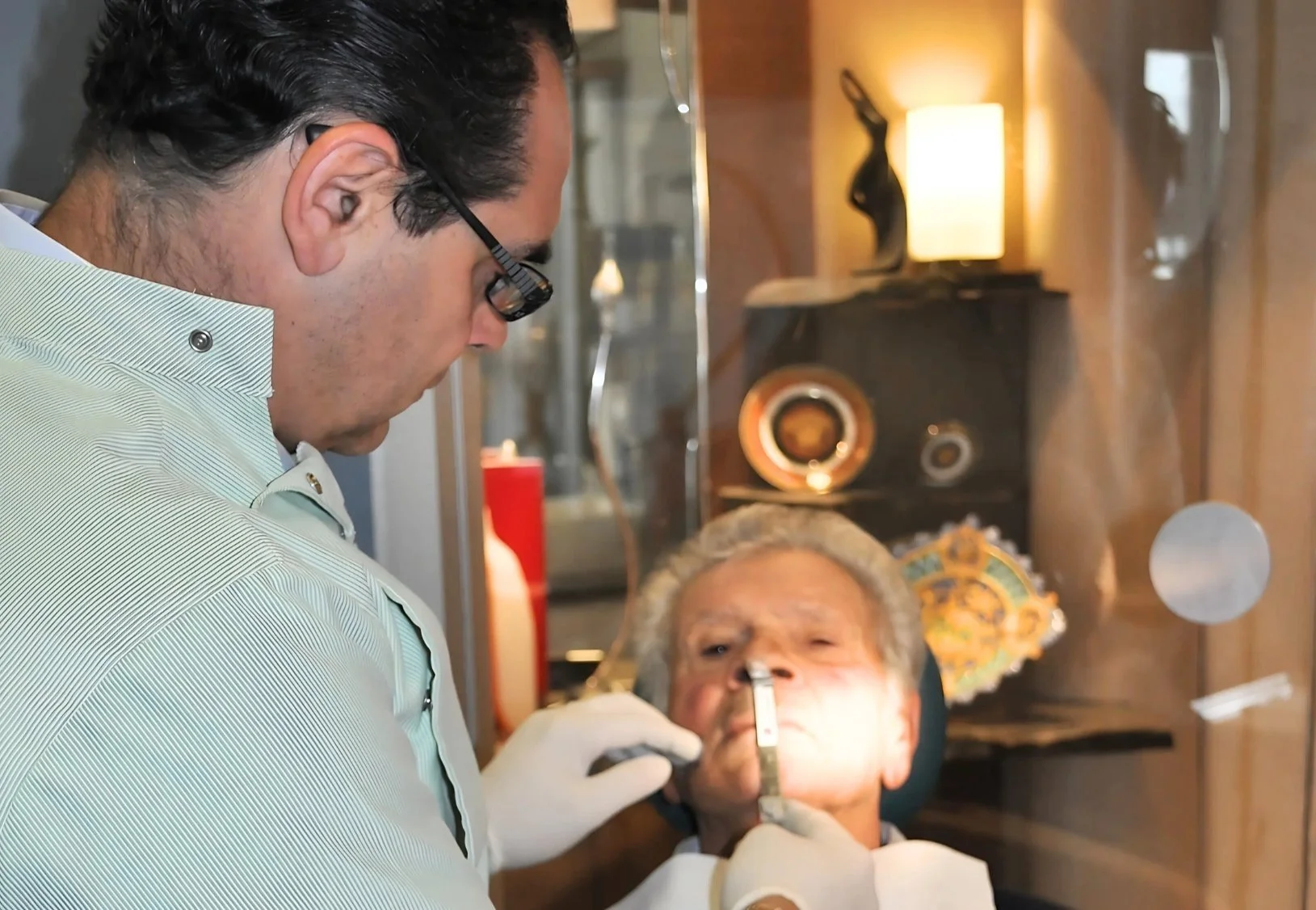 1st visit. Dr Sebastian Riggio performing clinical service on elderly patient in a clinic. Dentures Preston. Dentures Frankston.