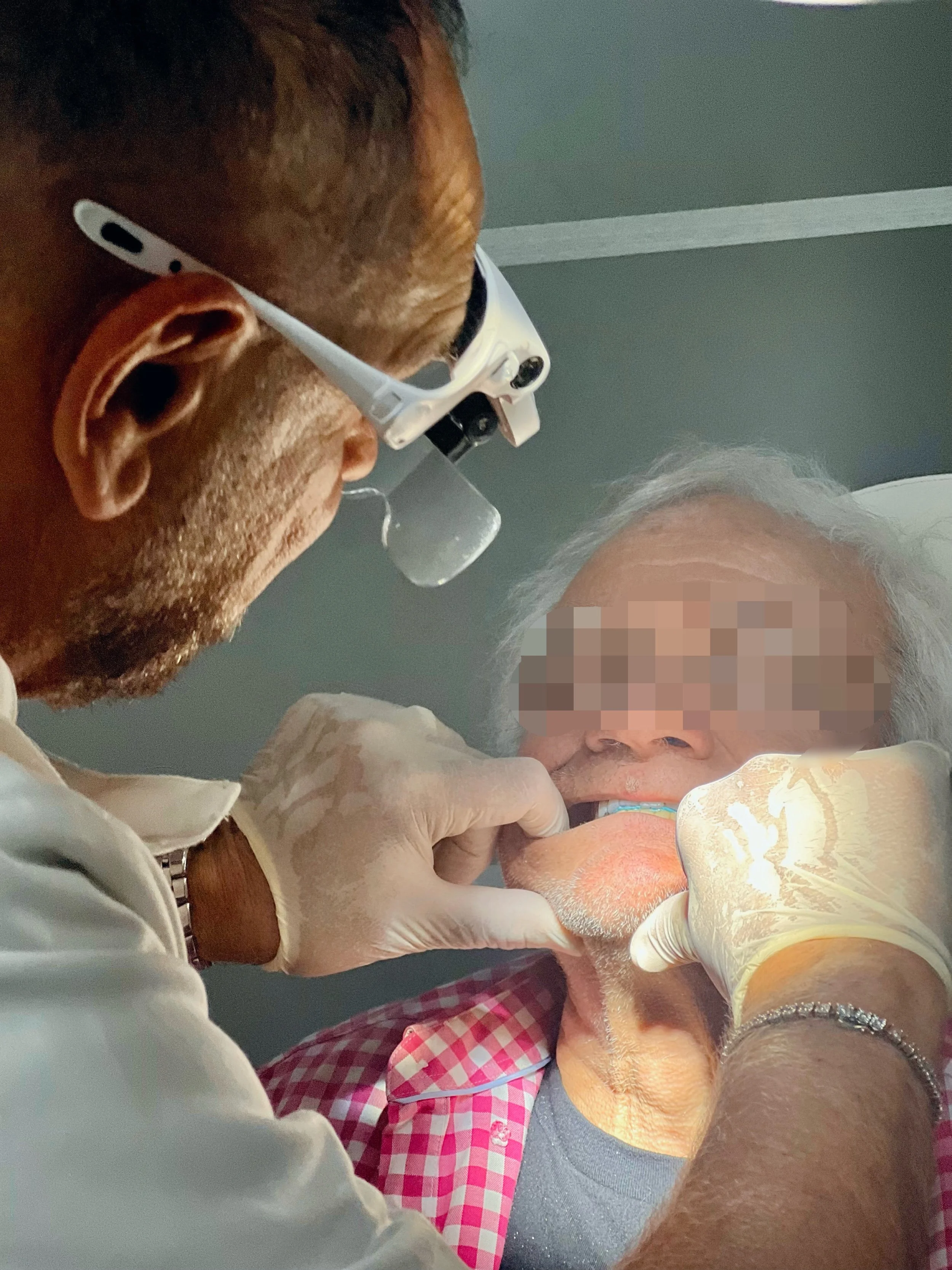 Dr Riggio and a patient during a Full Clinical Service. Dr Riggio is taking bite registration and getting an accurate impression of patients mouth