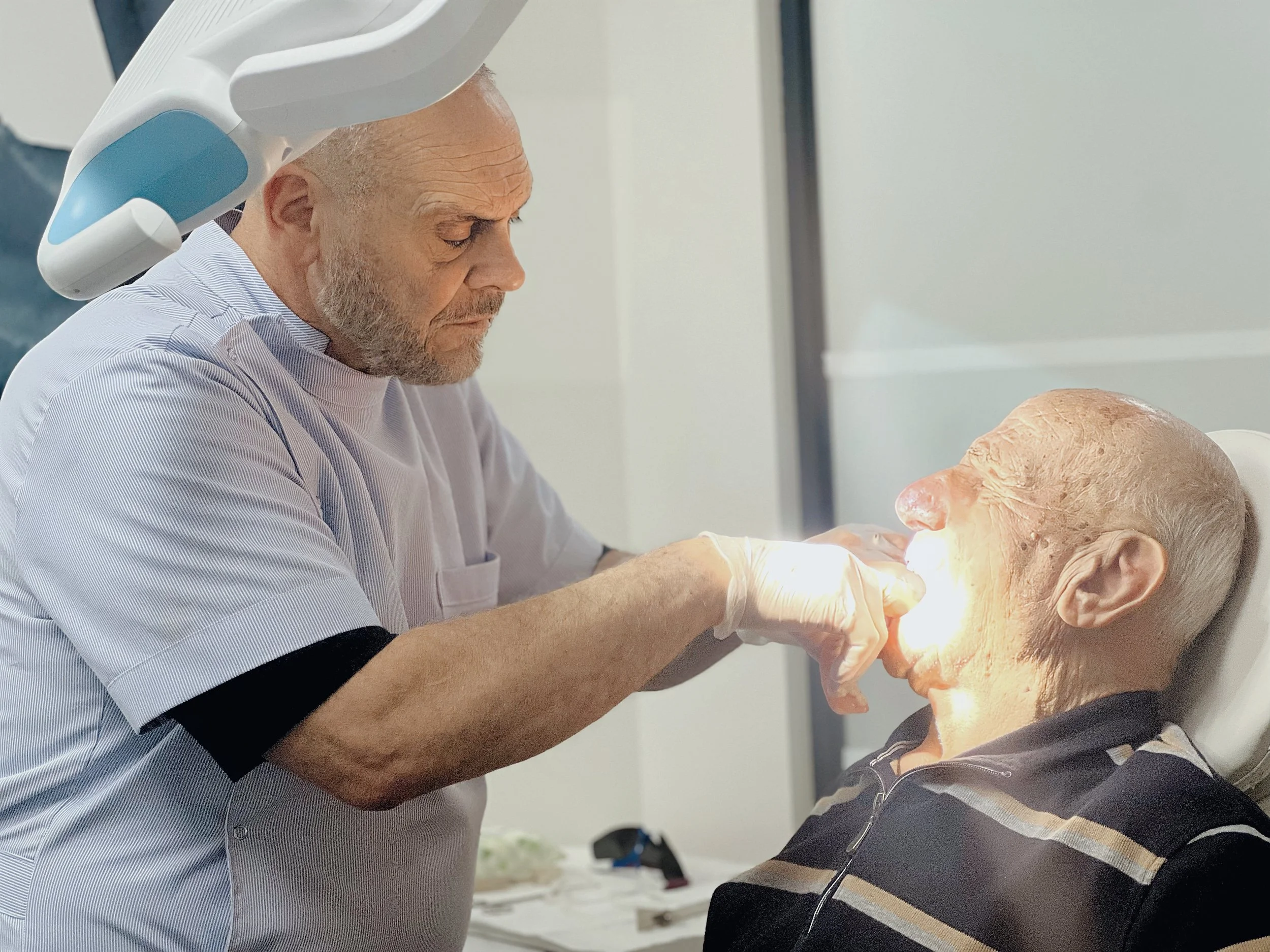 This image captures Dr. Sebastian Riggio in a clinical setting, reinforcing his status as a leading provider of implant-retained and full dentures in the Melbourne region.