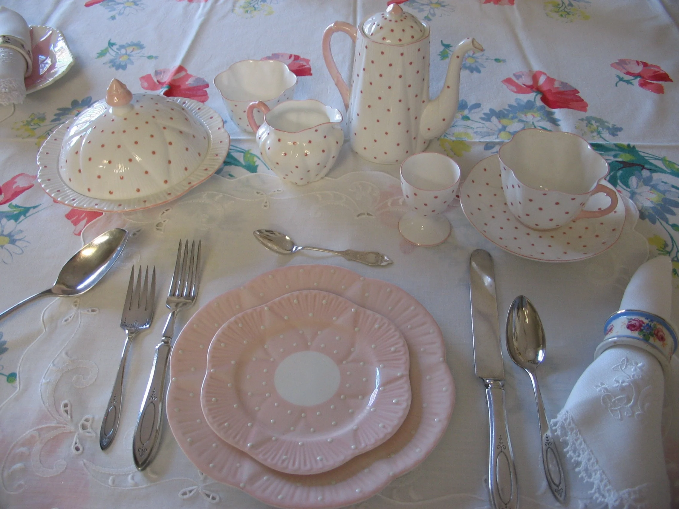 Shelley Salmon with White Dots. Salmon Pattern #12897/S37; Floral napkin ring Pattern #12964; 4 1/2" sterling teaspoon; Oneida Community Sterling flatware; placemats by "Hand Crafted Linens"; napkins hand embroidered from Ireland, tablecloth - Wilend