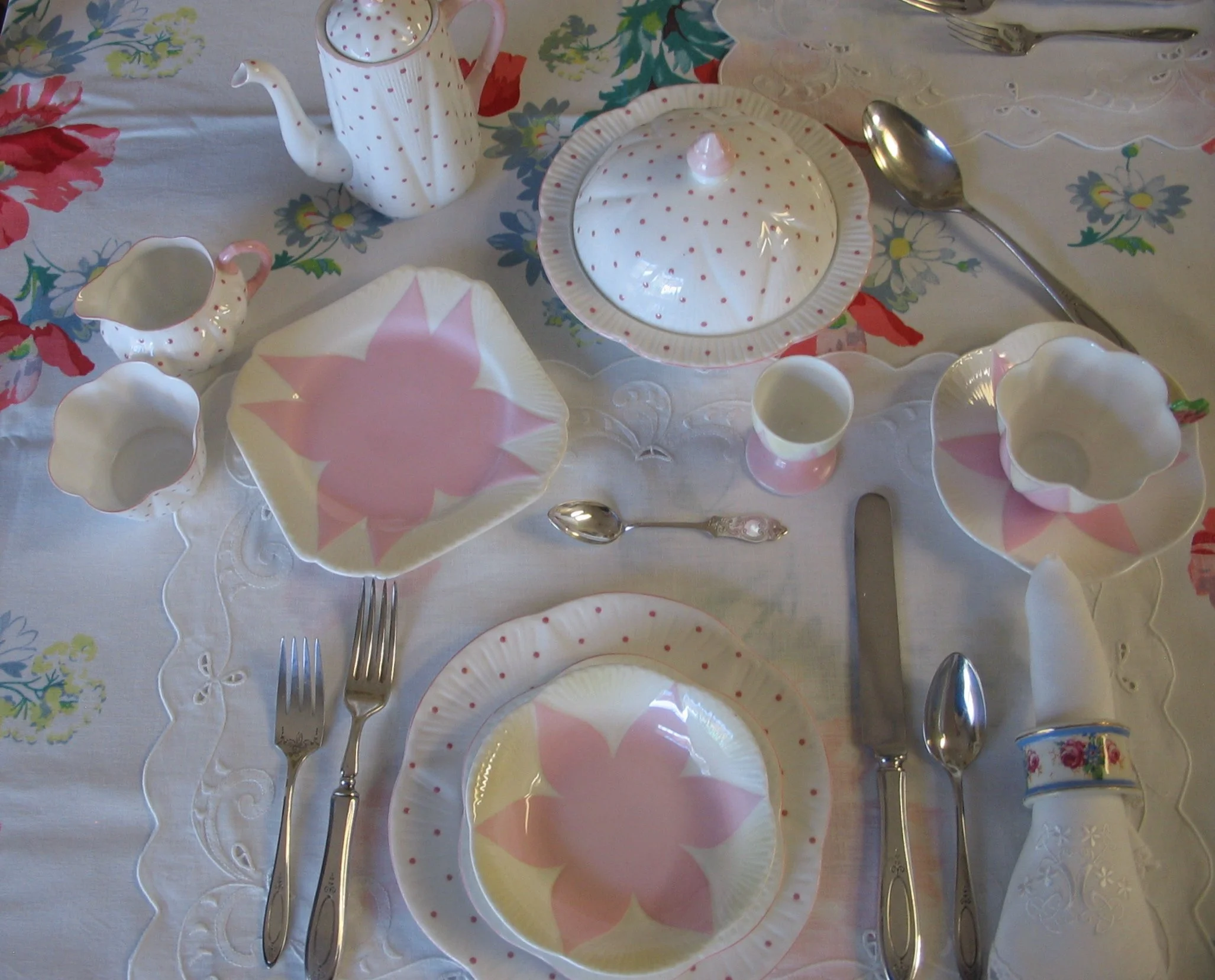 Shelley Pink Star with shaded yellow segment Pattern #11993; Floral napkin ring Pattern #12964; 4 1/2" sterling teaspoon; Oneida Community Sterling flatware; placemats by "Hand Crafted Linens"; napkins hand embroidered from Ireland, tablecloth - Wile
