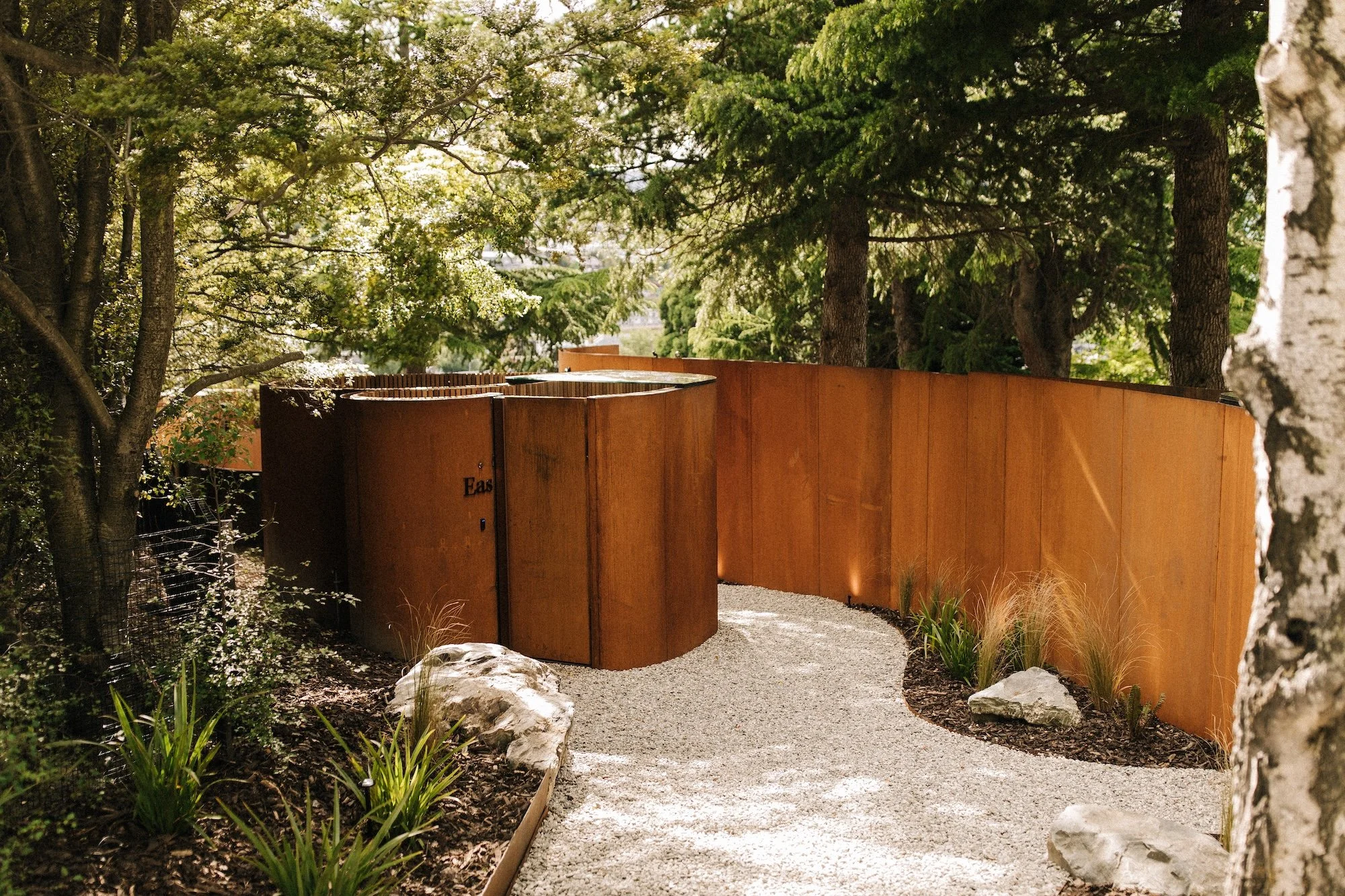 Landscaped surrounds and Corten steel walls of Bathe Hot Pools in Queenstown.
