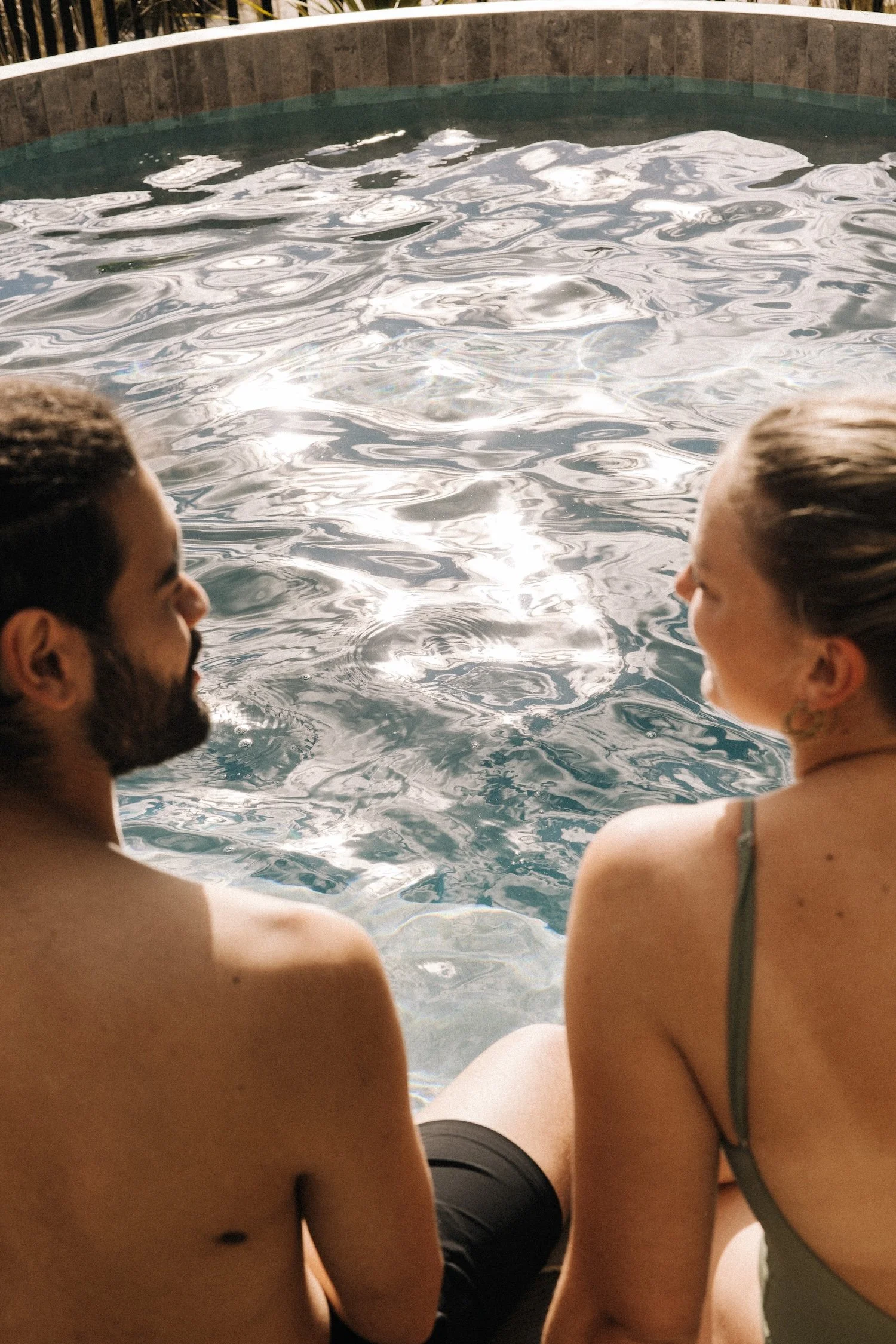 Two bathers talking and connecting at Bathe hot pools Queenstown.