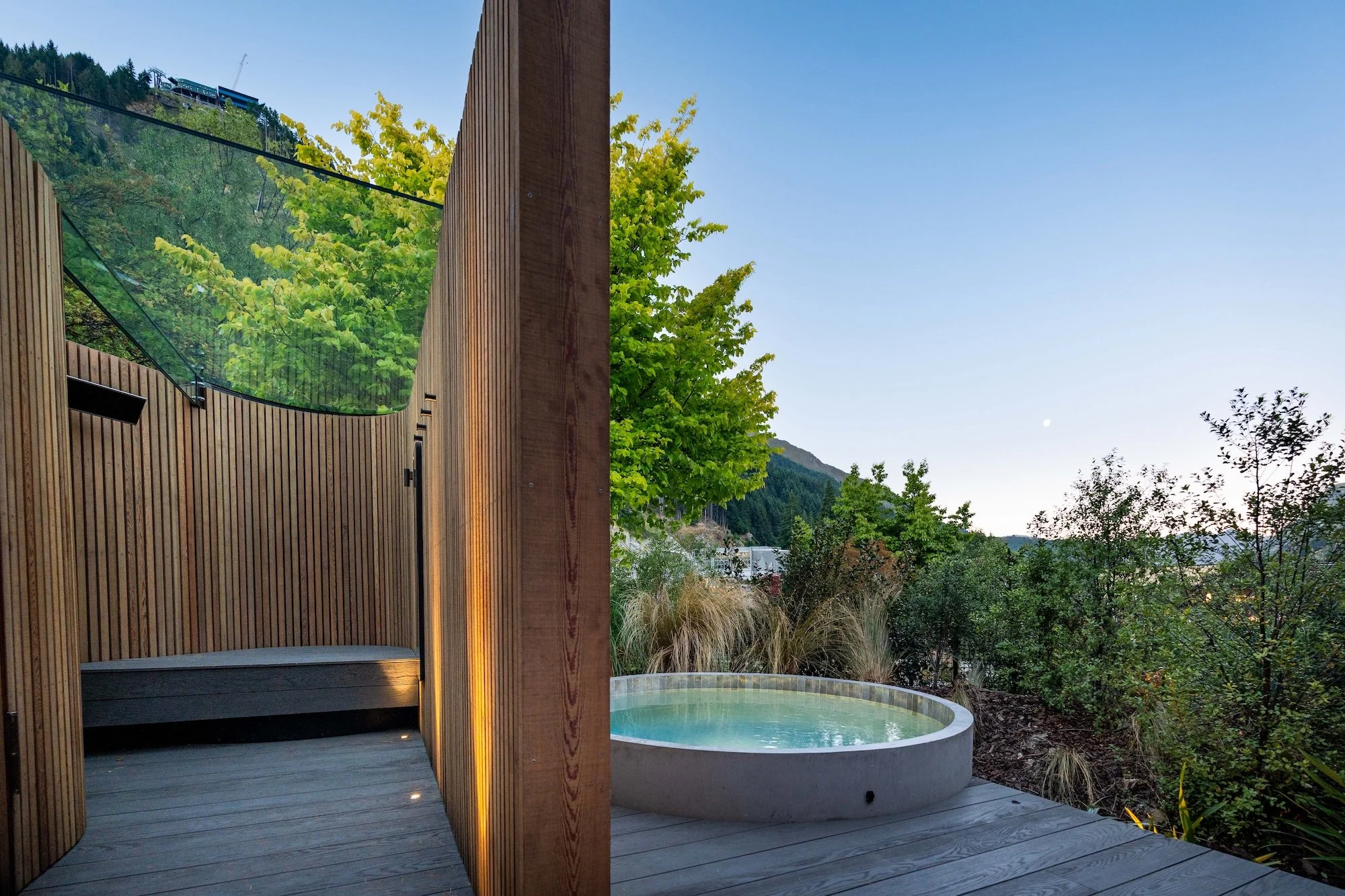 Bathe hot pools at dusk in Queenstown.